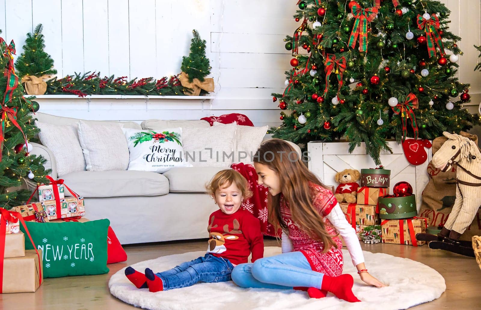 Children near the Christmas tree. Selective focus. Kid.