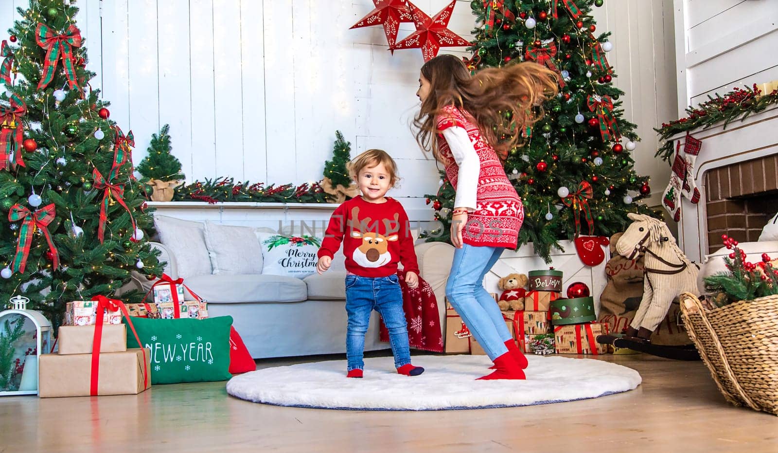 Children near the Christmas tree. Selective focus. Kid.