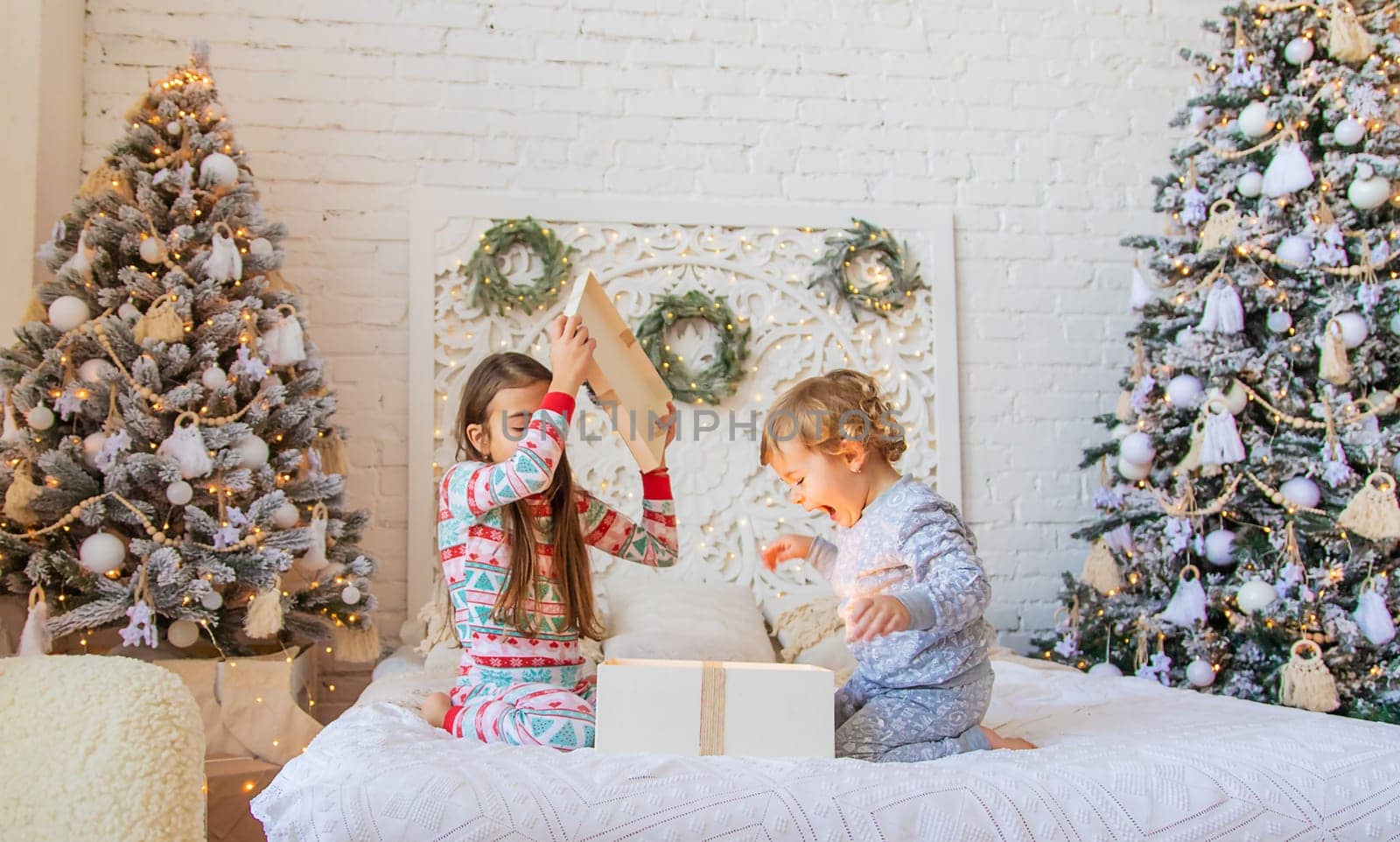 Child open Christmas gifts under the tree. Selective focus. Kid.