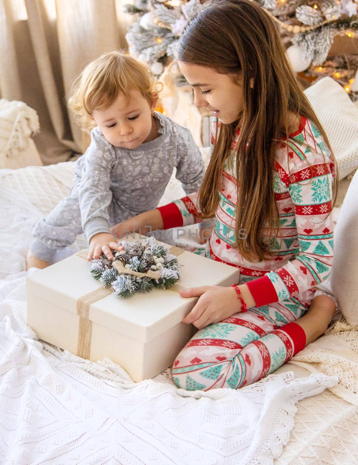 Child open Christmas gifts under the tree. Selective focus. Kid.