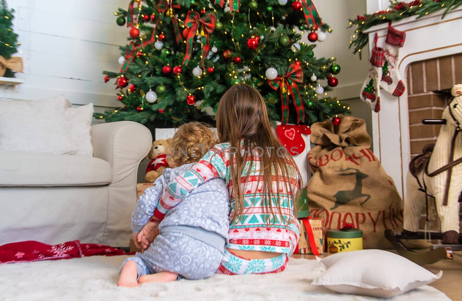 Children look at the Christmas tree. Selective focus. Kid.