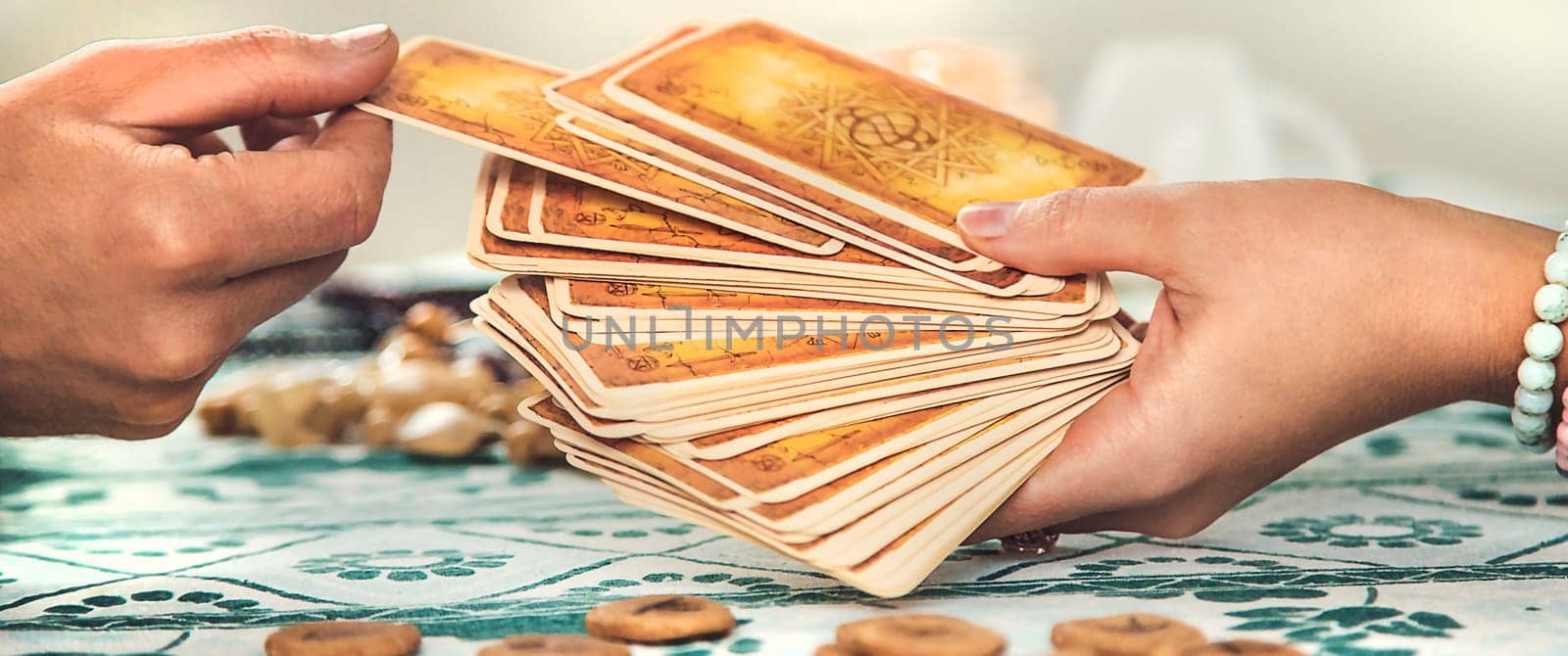 A fortune teller reads with tarot cards. Selective focus. Woman.