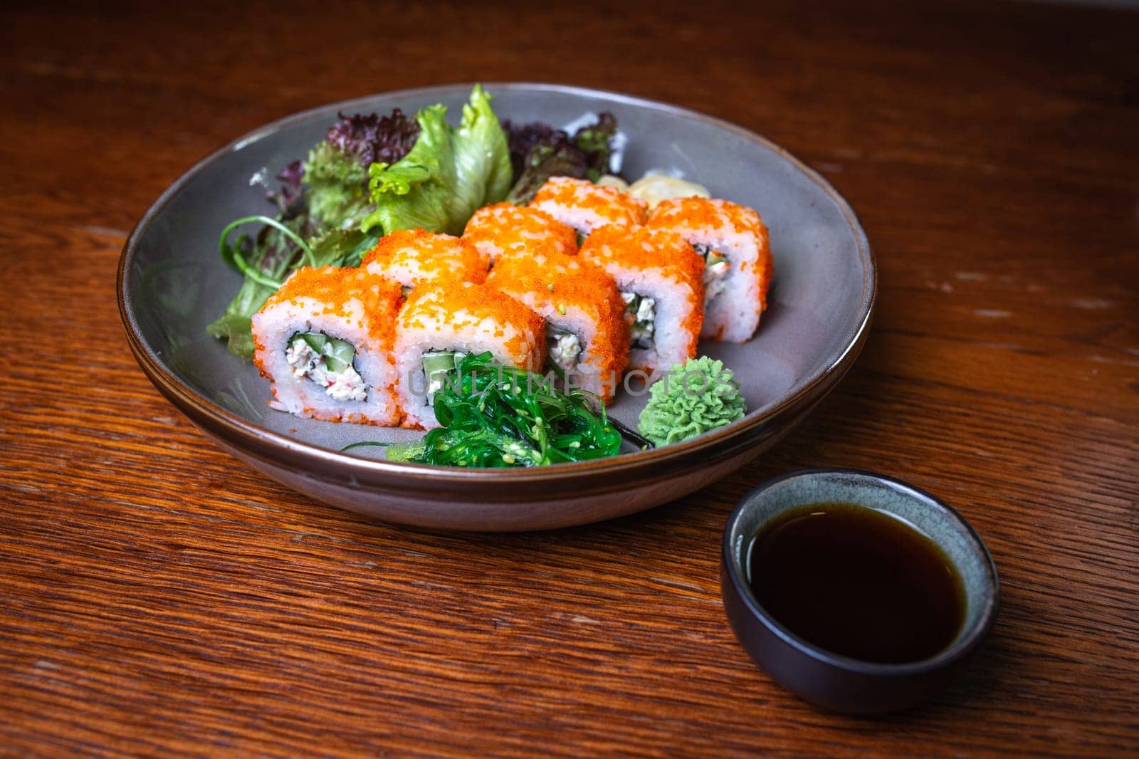 rolls with red caviar, wasabi, nori on a plate. Japanese kitchen by Pukhovskiy