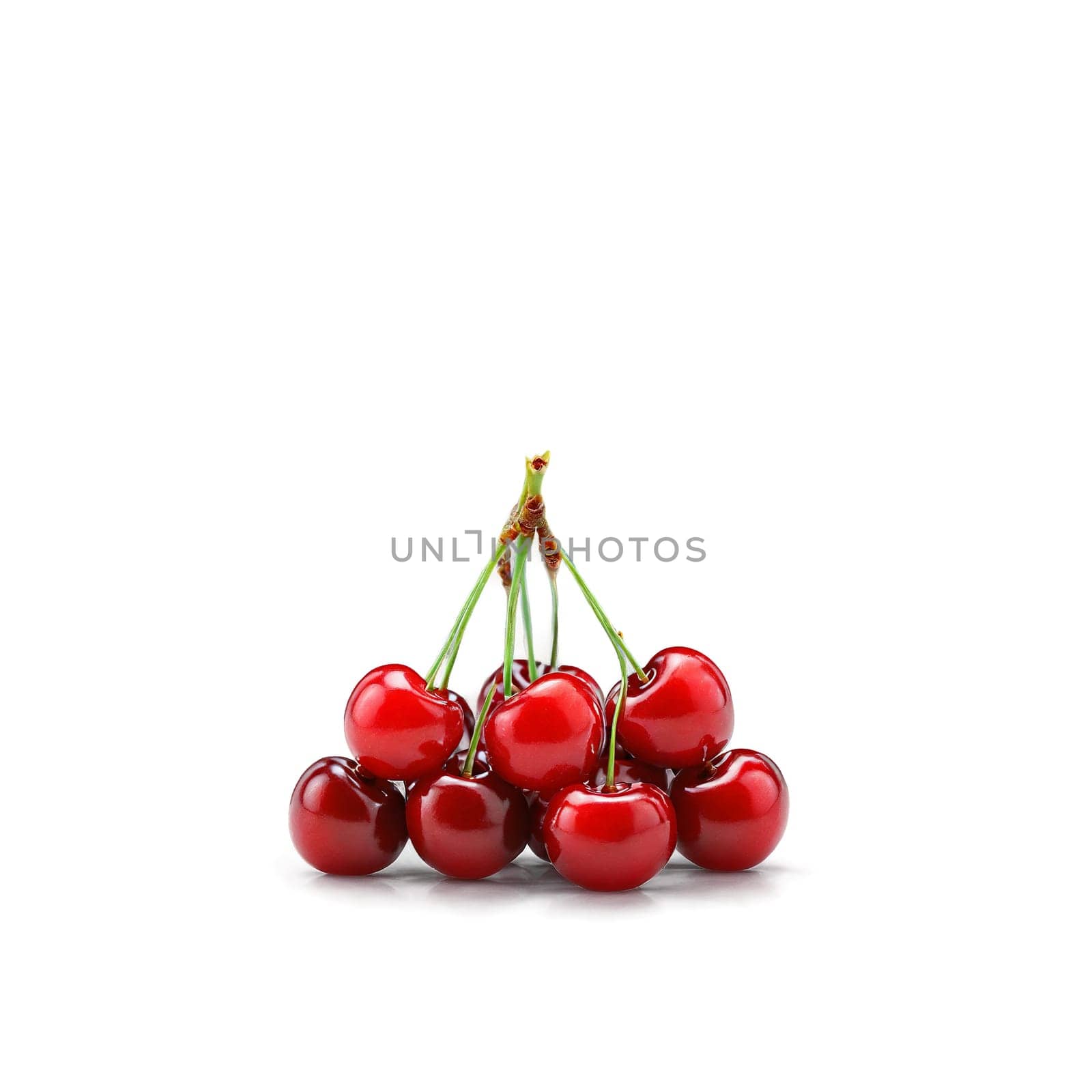 Acerola with bright red cherries and green stems in scattered bunch Food and culinary concept by panophotograph