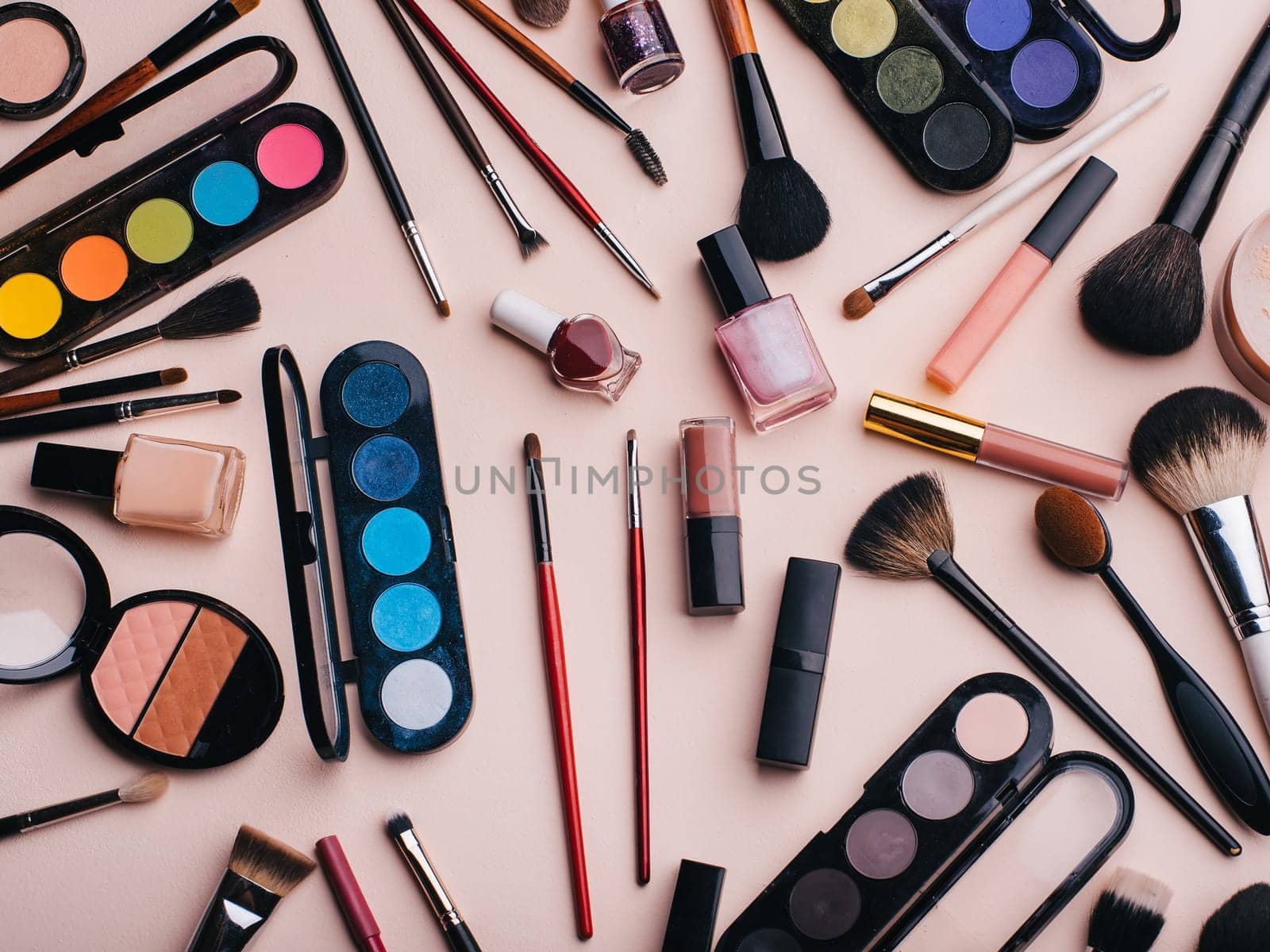 set of female cosmetics for eye makeup, skin face care. Professional products for beauty on a pink background. Top view, flat lay