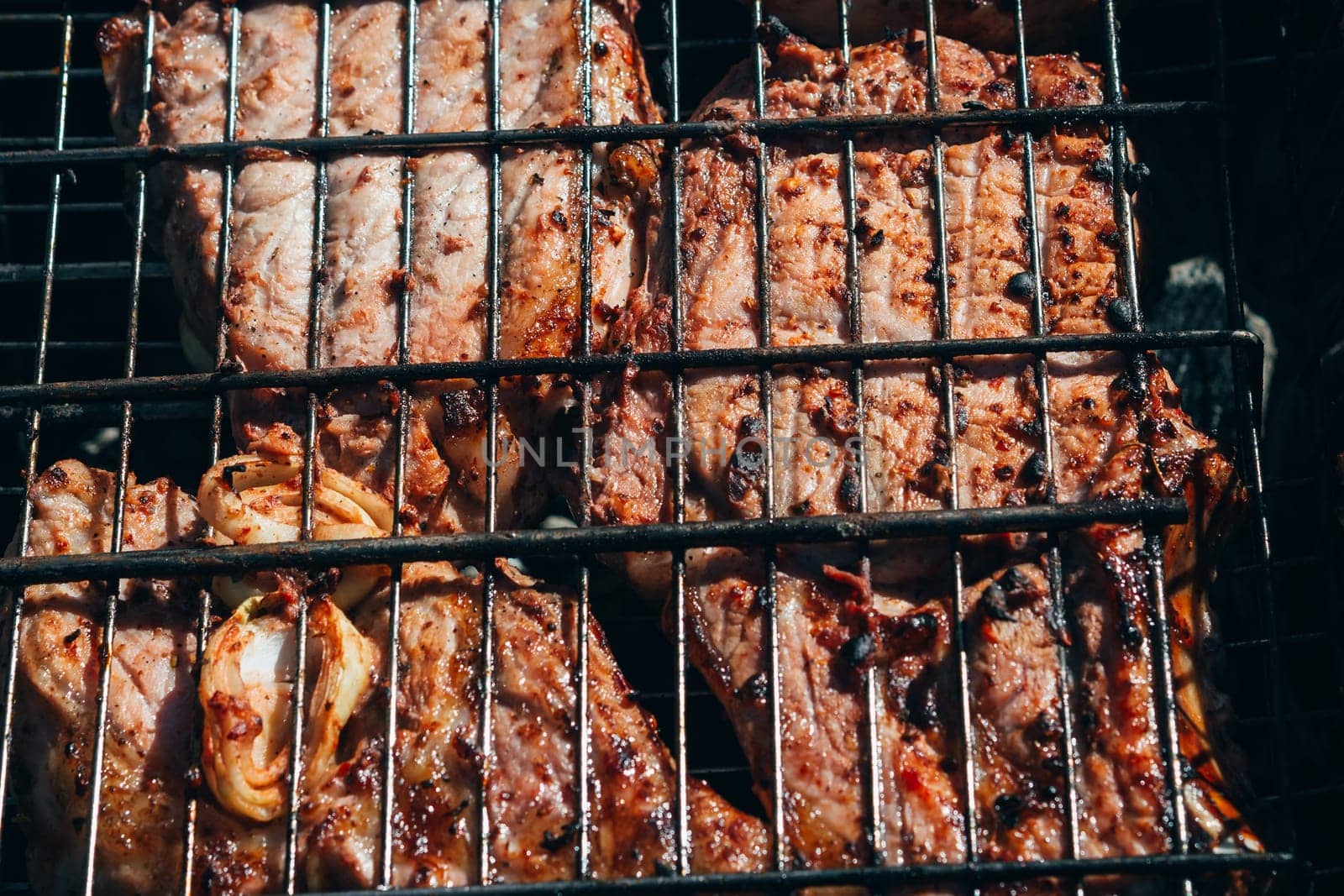 pork meat fried on a barbecue grill close-up