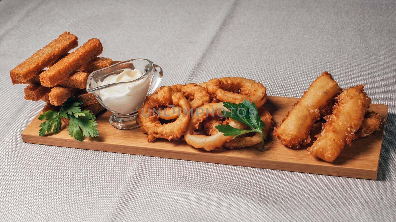 crackers, onion rings and other beer snacks with sauce