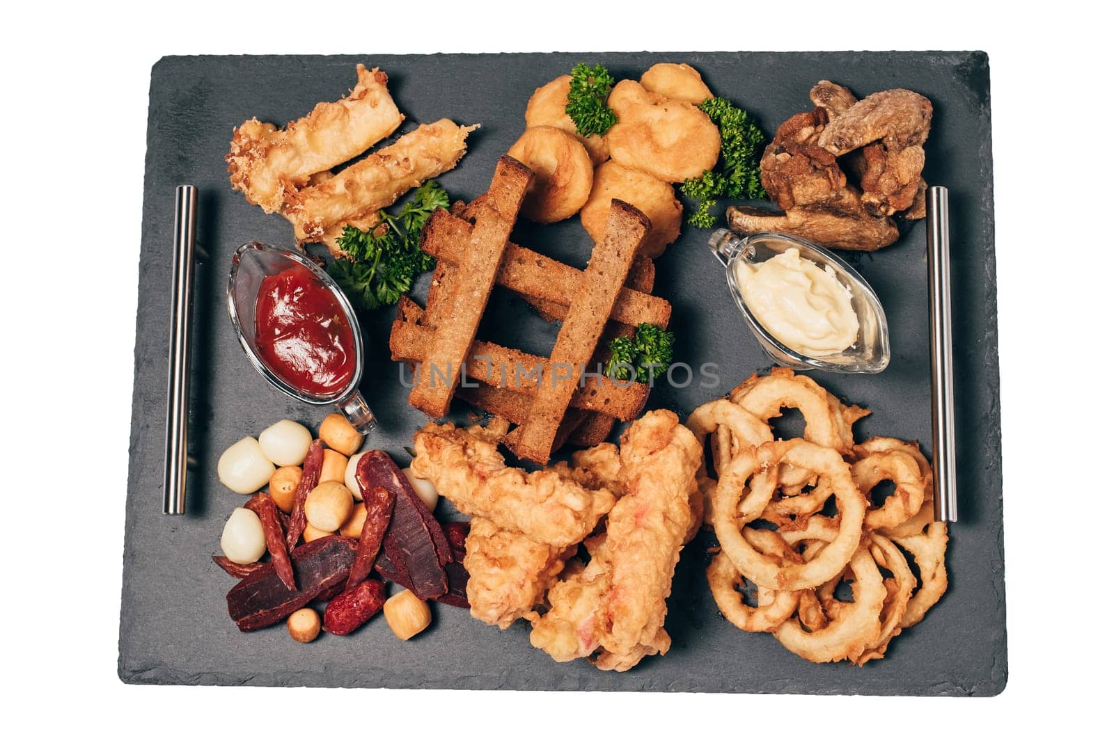 set of snacks for beer from crackers, onion rings, sausage and cheese and sauce