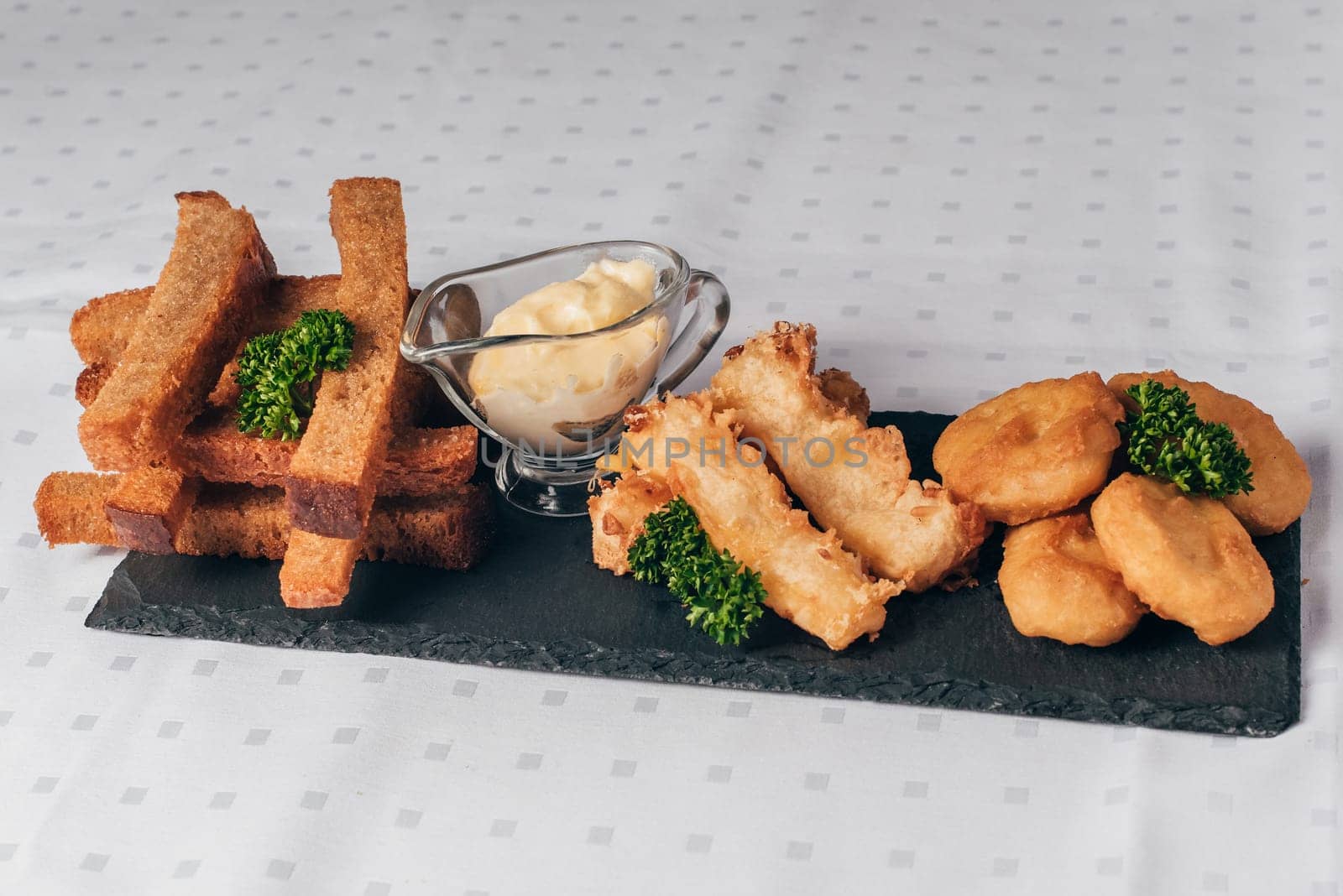 set of snacks, breaded and served with sauce