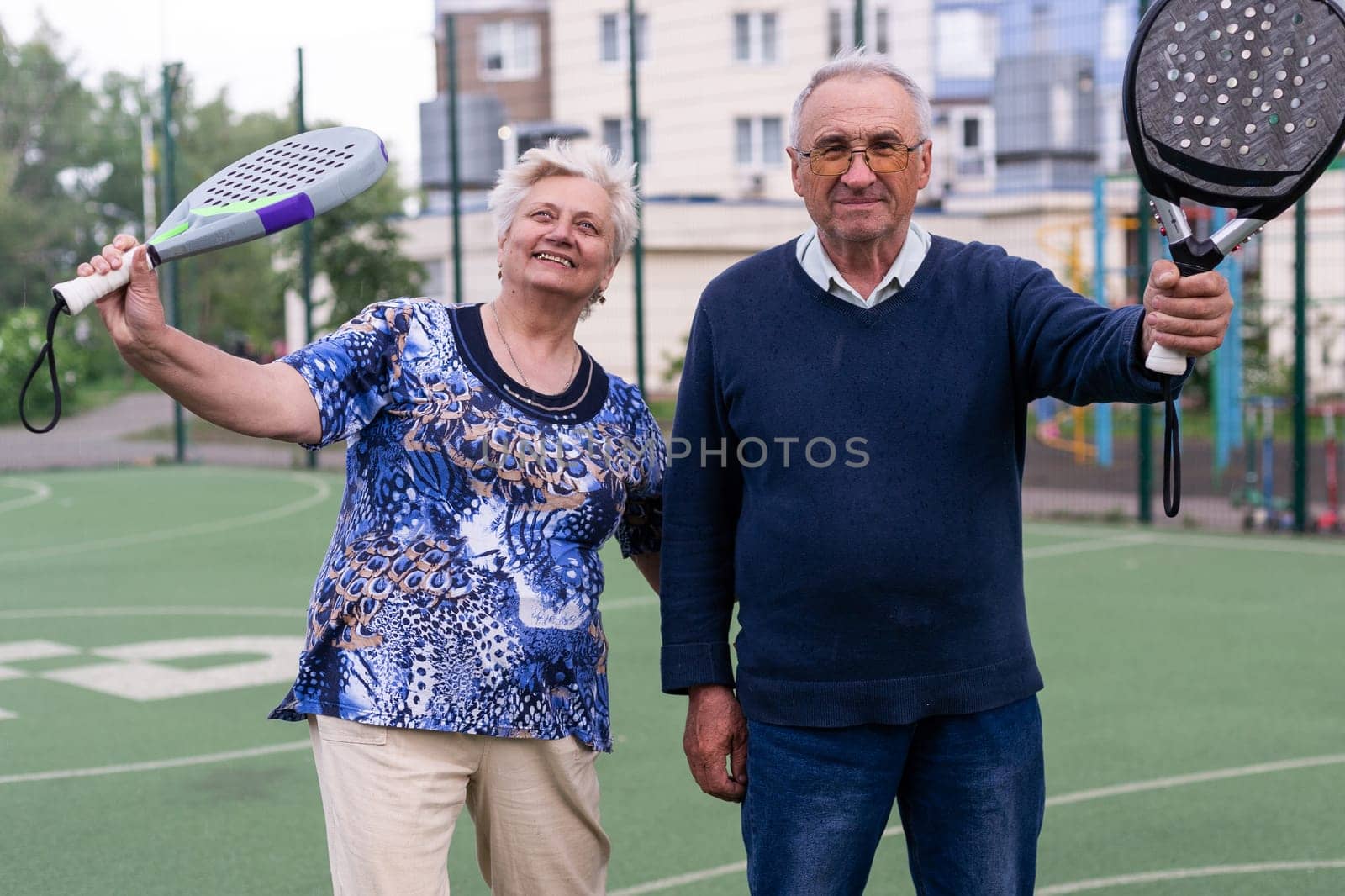 senior man playing paddle tennis a by Andelov13