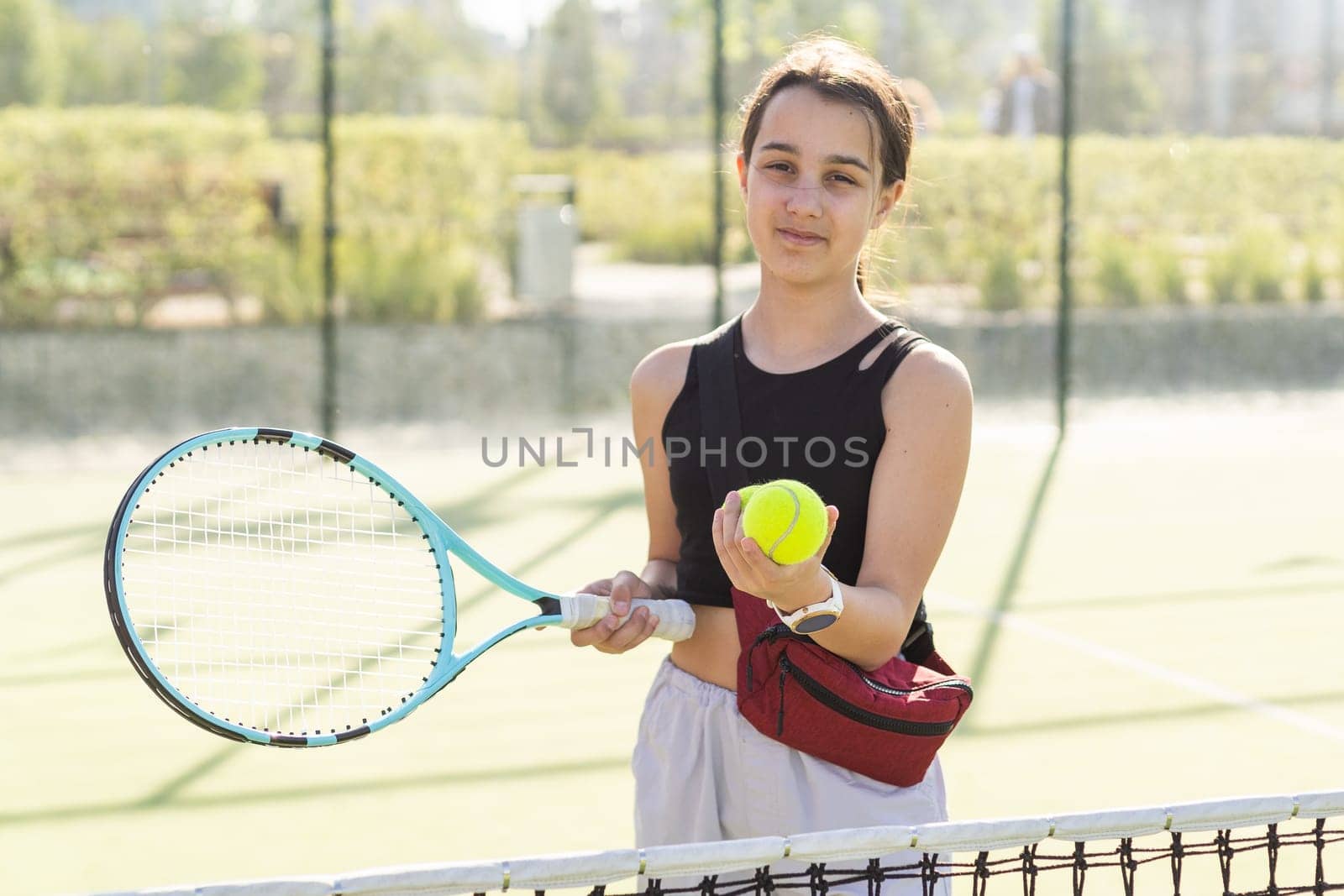 A person holding a racket on a court. High quality photo