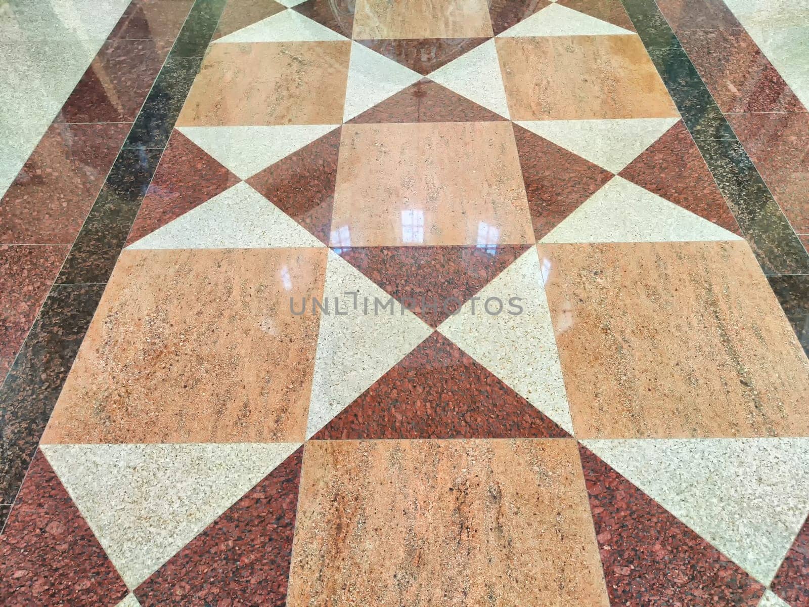 Mosaic tiles are shiny on the path, sidewalk or indoors. A glossy floor adorned with a diamond-shaped mosaic tile design