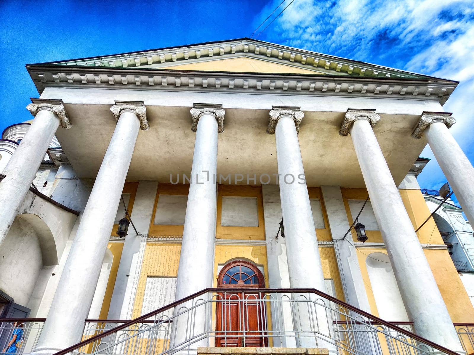 Neoclassical Architecture Under Blue Sky. Stately building with columns and steps against a clear sky