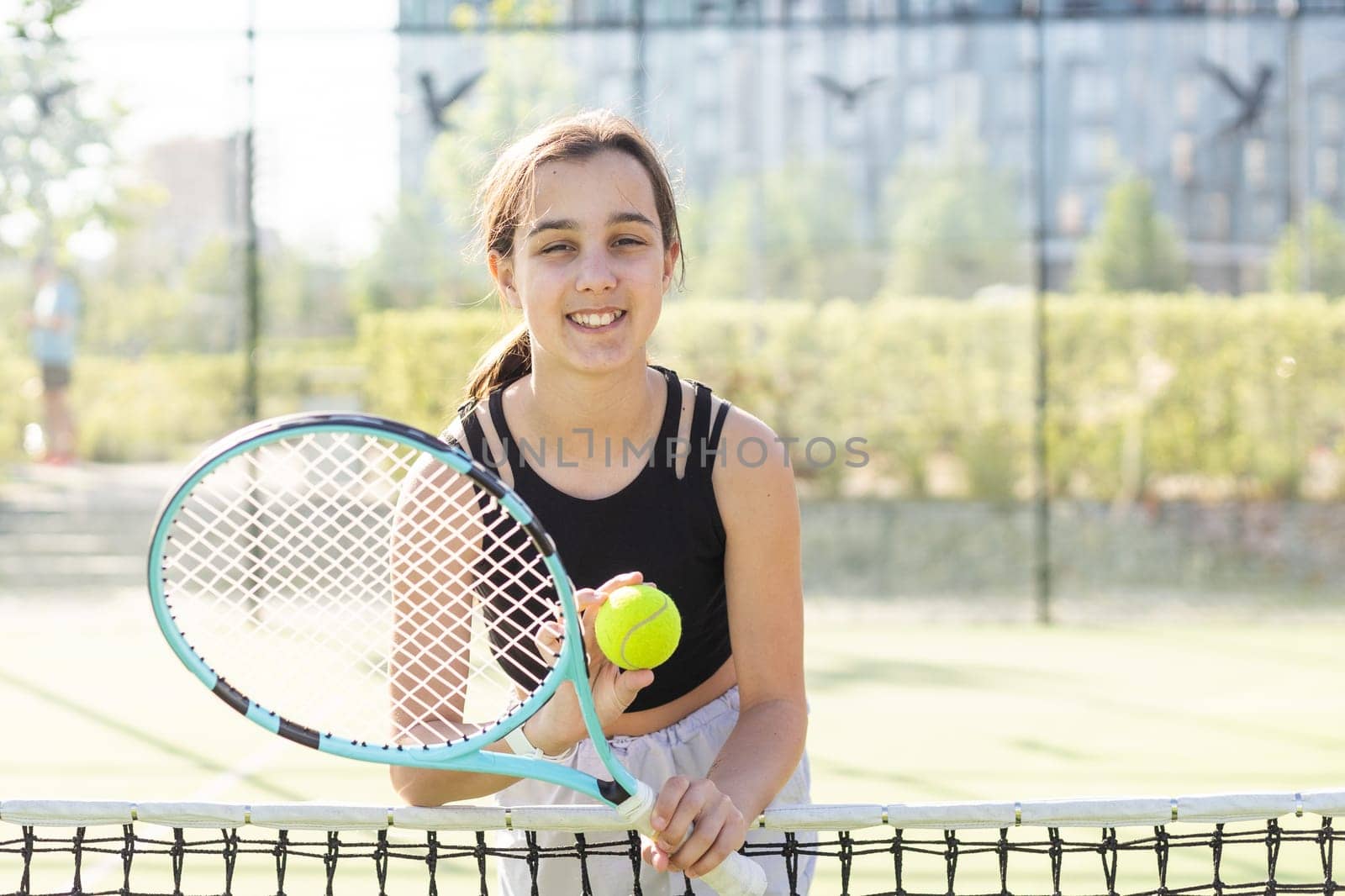 Girl with a racket on the tennis court. by Andelov13