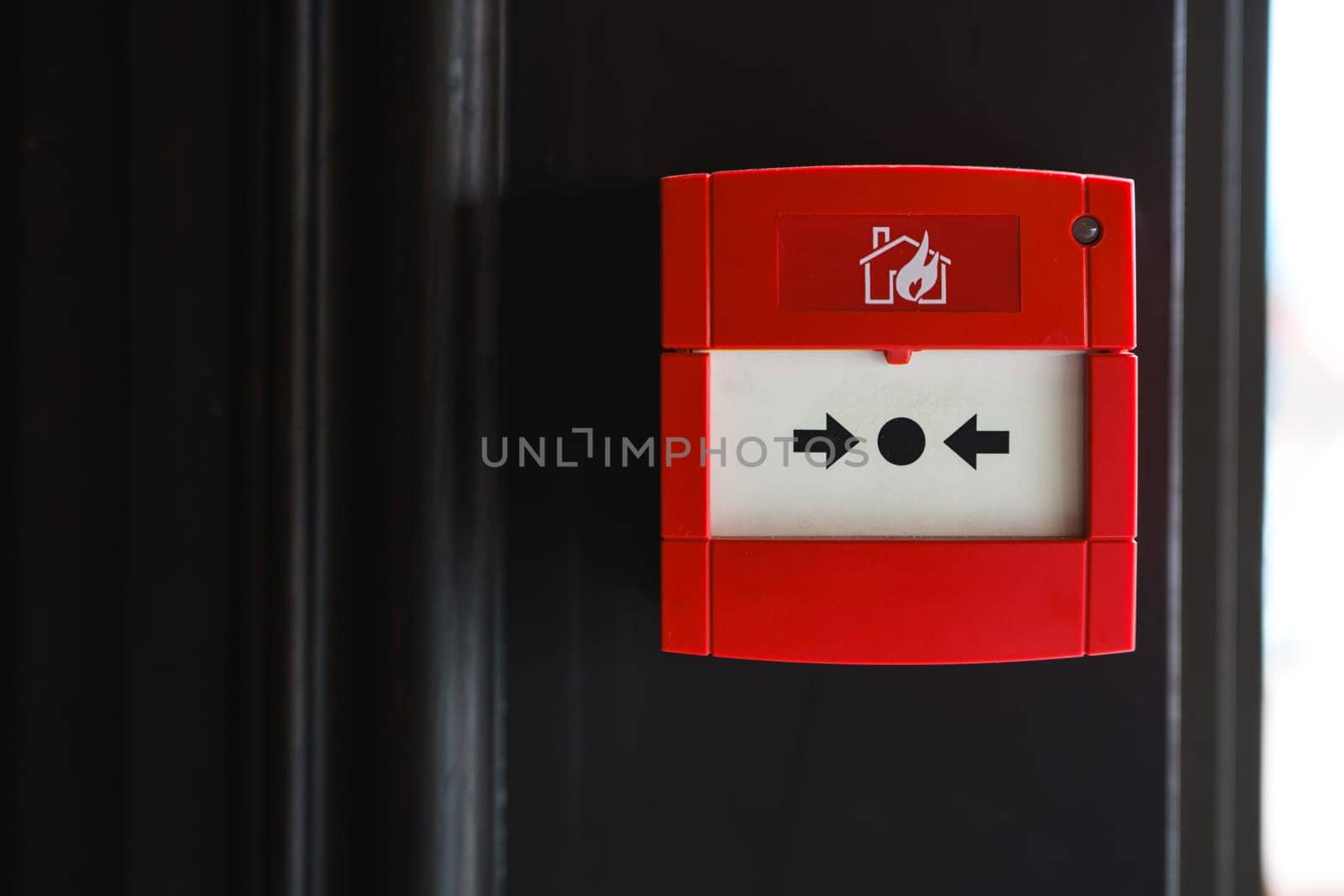 Full front view of outdoor wall mounted fire alarm button
