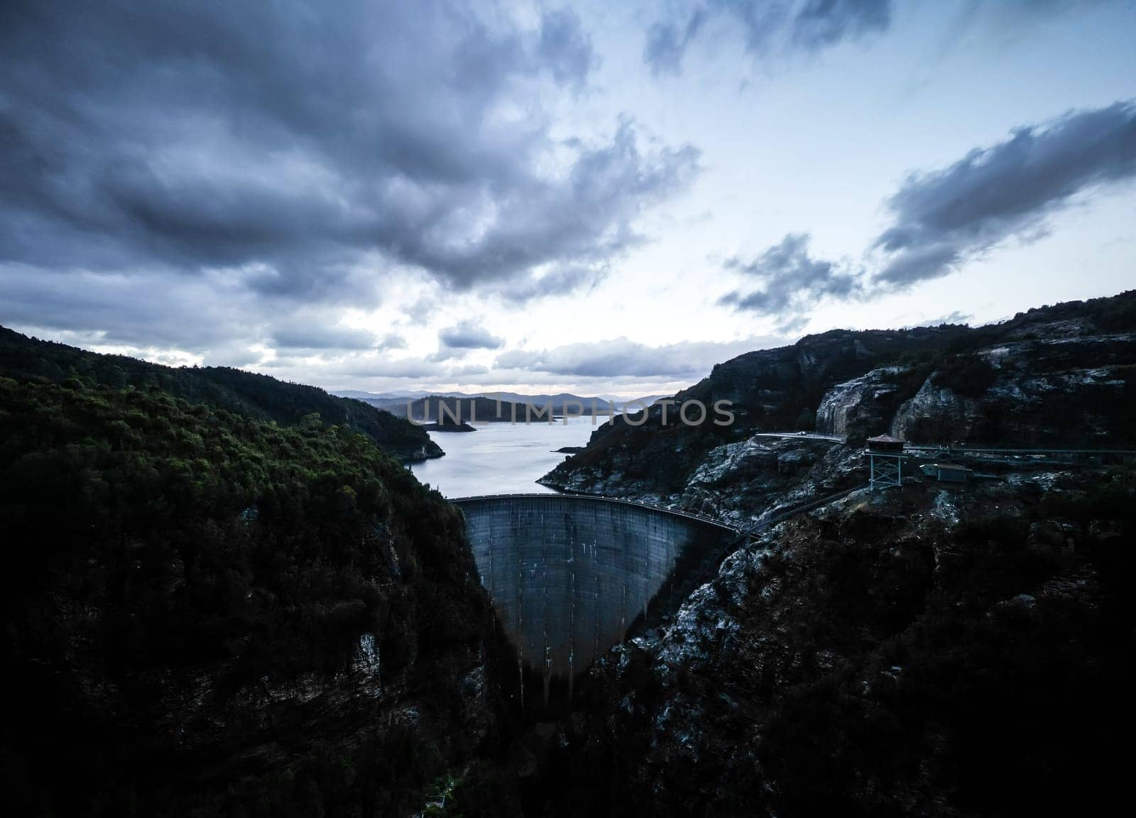 View of the Gordon Dam on a cool summer's day. It is a unique double curvature concrete arch dam with a spillway across the Gordon River near Strathgordon, South West Tasmania, Australia