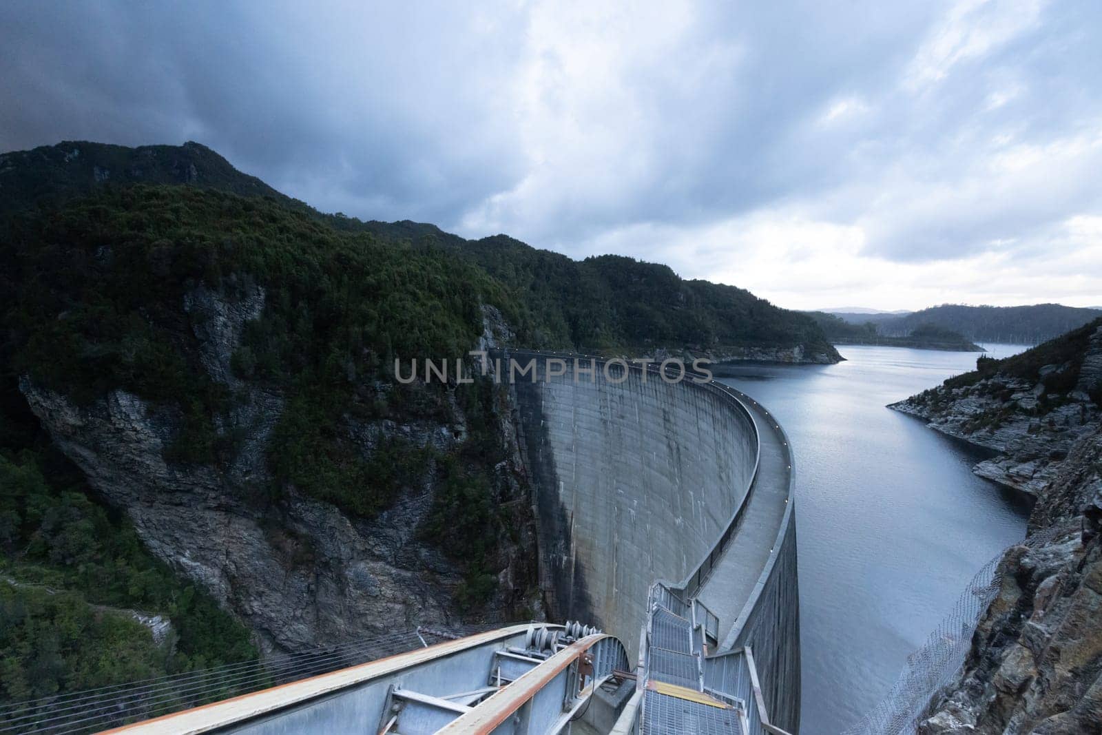 View of the Gordon Dam on a cool summer's day. It is a unique double curvature concrete arch dam with a spillway across the Gordon River near Strathgordon, South West Tasmania, Australia