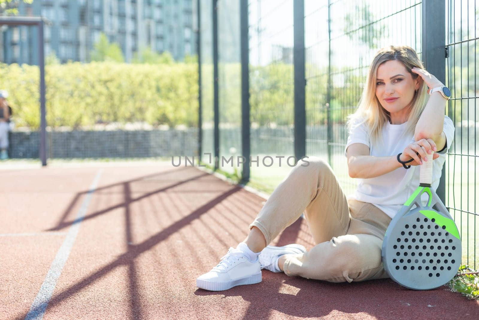 A female paddle tennis player after playing a match. High quality photo