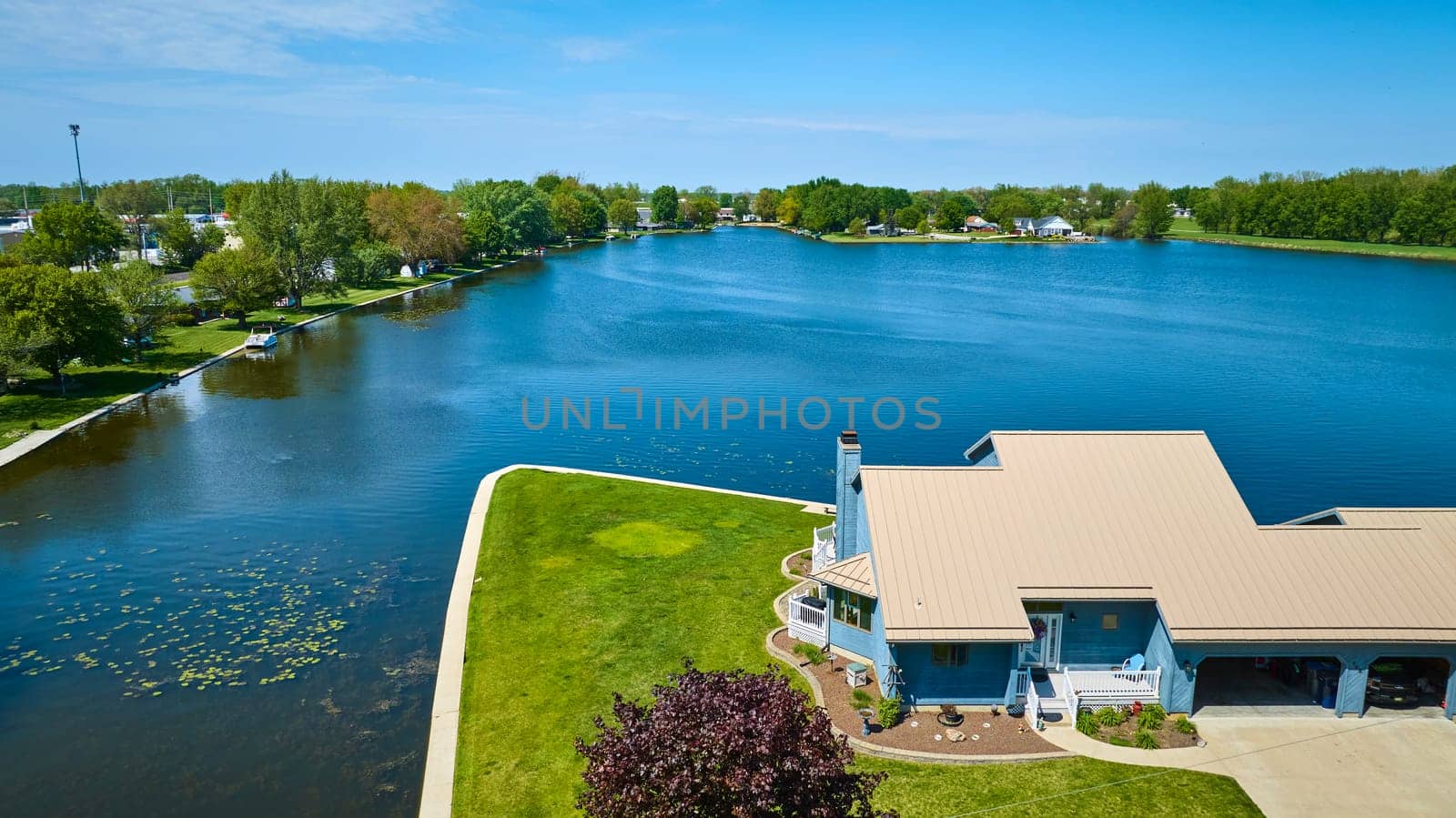 Aerial view of a peaceful lakeside community in Warsaw, Indiana, showcasing upscale, tranquil living.