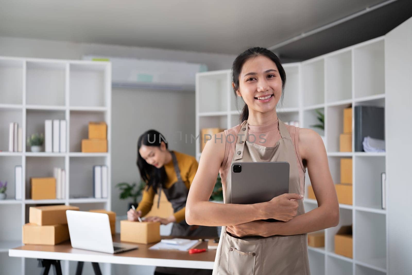 Asian woman working with tablet in online business office.