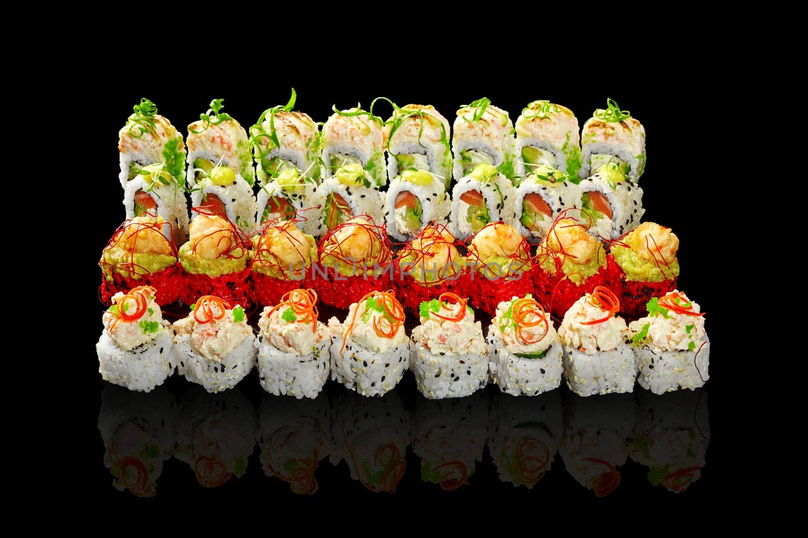 Enticing set of sushi rolls with various fillings and toppings on black by nazarovsergey