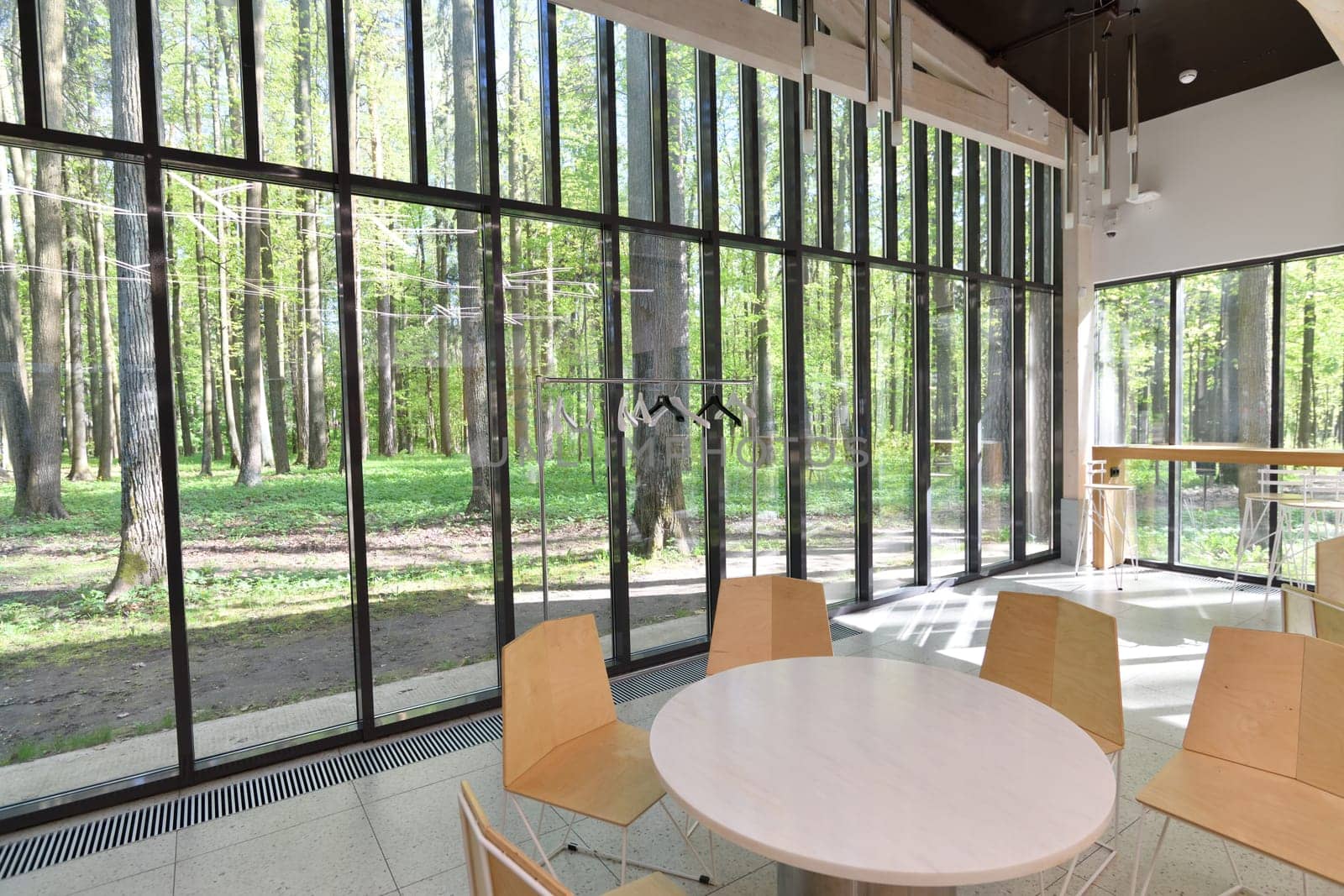 Cafe with glass walls and a forest views