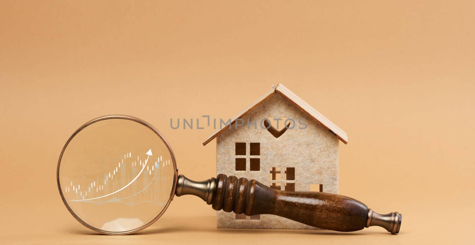 Wooden house and a magnifying glass, representing the concept of real estate purchase by ndanko