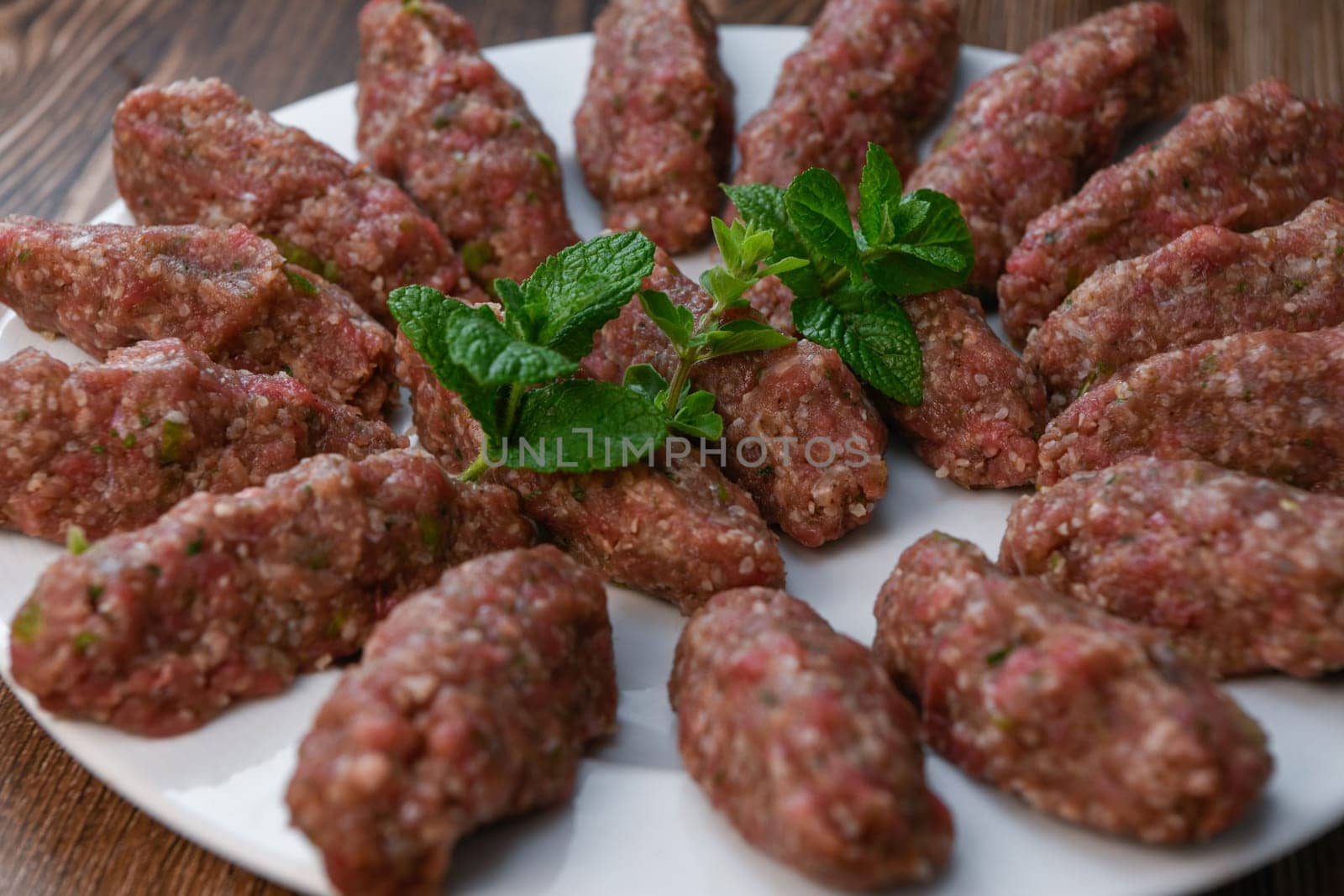 RECIPE FOR LEBANESE KEBBE NAYYHE, RAW MINCED BEEF, MARJORAM, MINT, ONIONS, CRUSHED WHEAT, SEVEN SPICES, CINNAMON, CAYENNE PEPPER. High quality photo