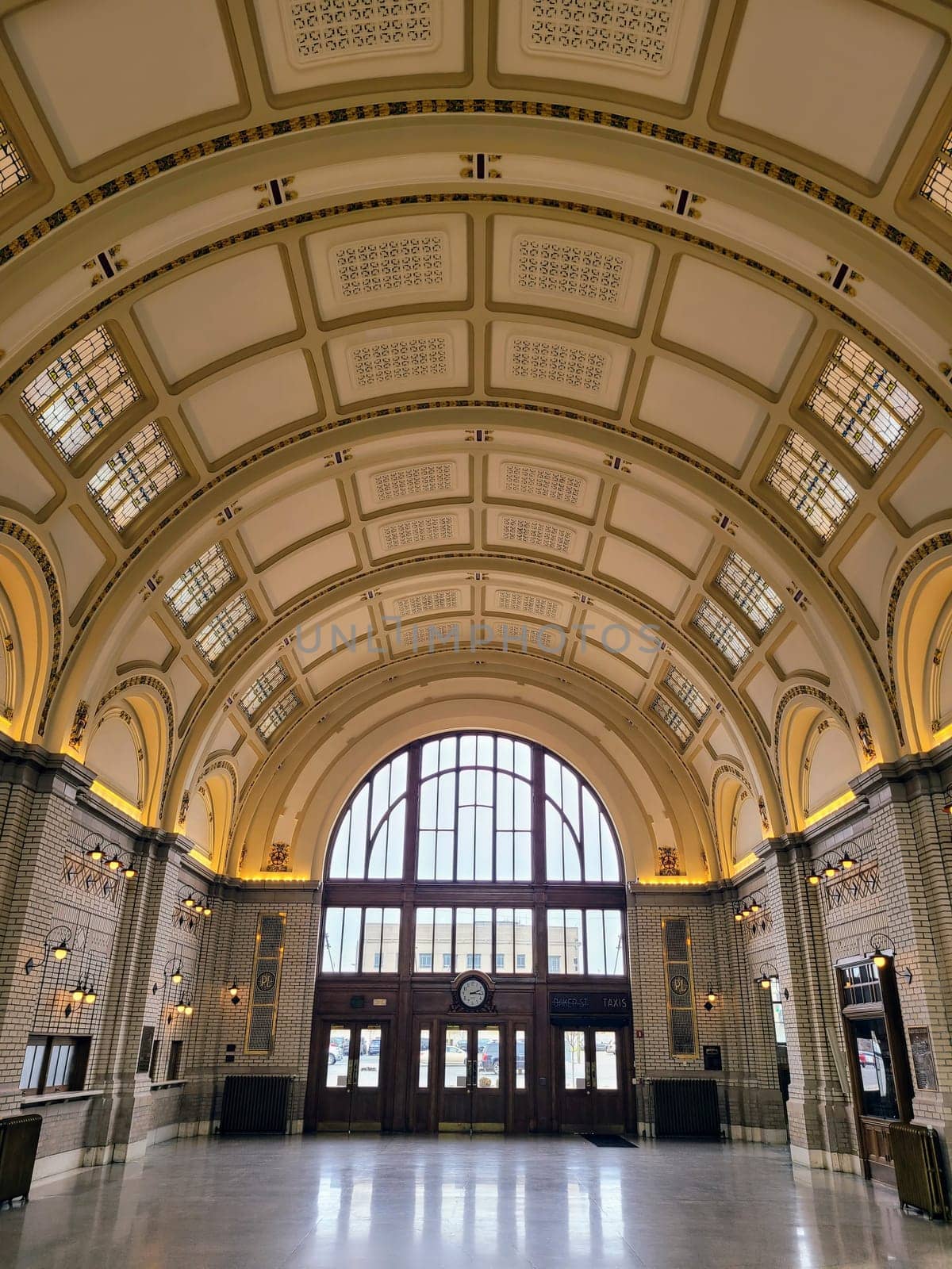 Elegant historic train station in Fort Wayne, Indiana featuring ornate arches, a grand clock, and sunlit interiors.