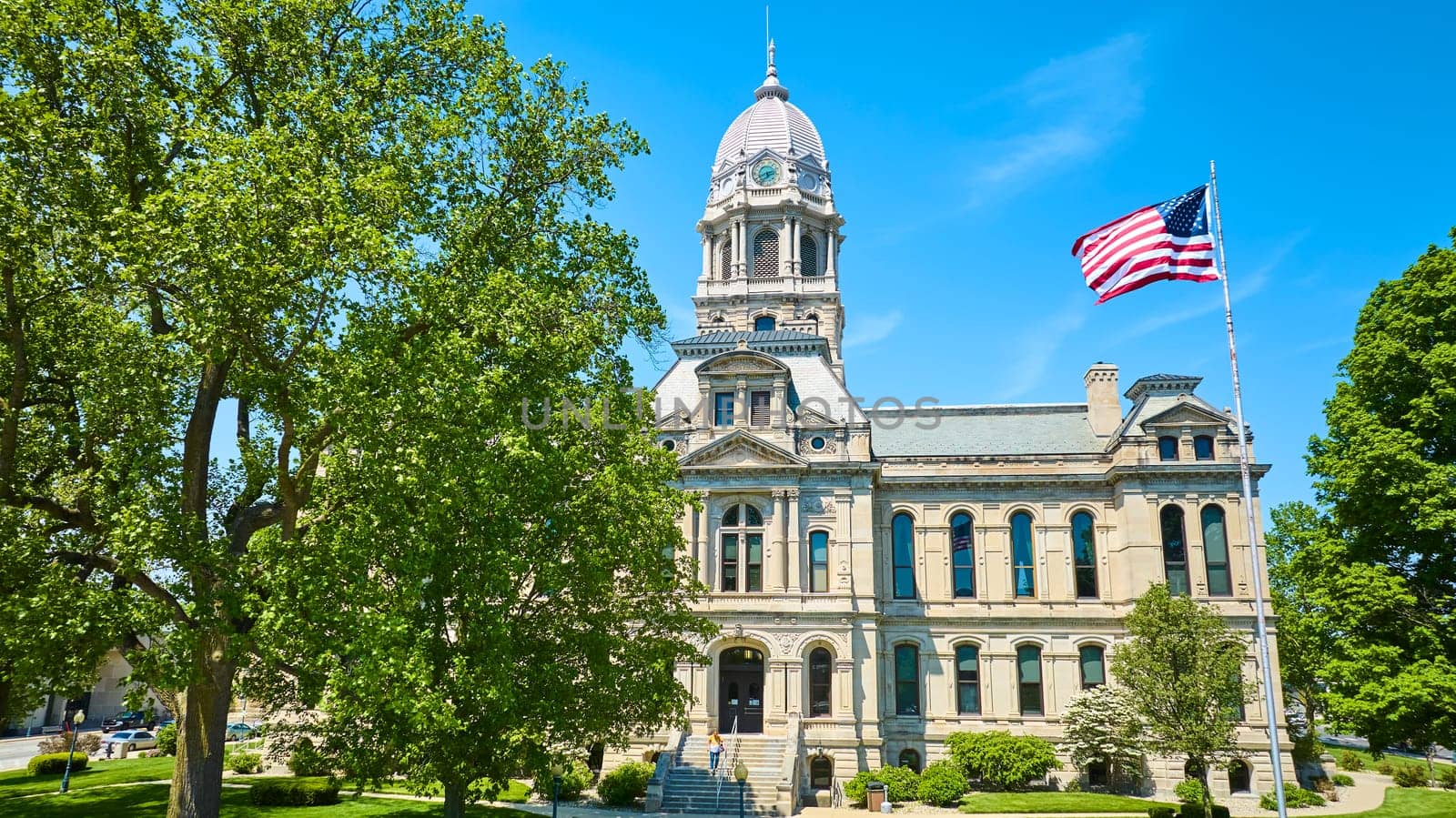 Majestic Kosciusko County Courthouse in Warsaw, Indiana under a clear blue sky, symbolizing tradition and authority.