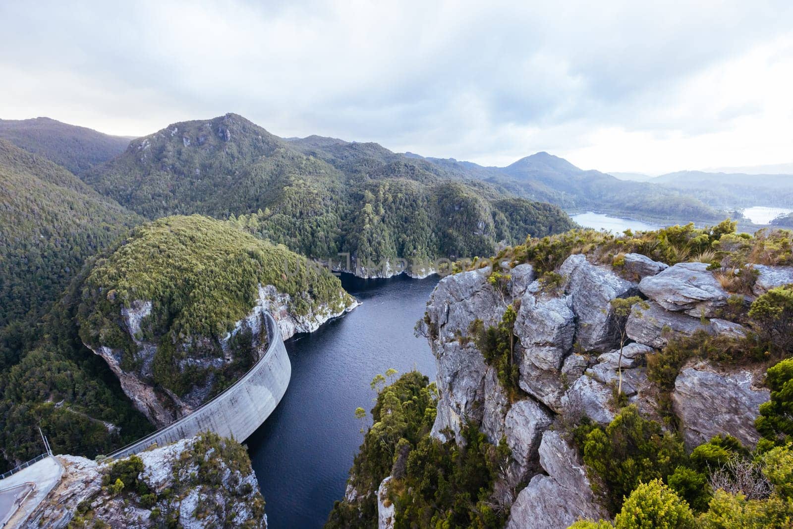 View of the Gordon Dam on a cool summer's day. It is a unique double curvature concrete arch dam with a spillway across the Gordon River near Strathgordon, South West Tasmania, Australia