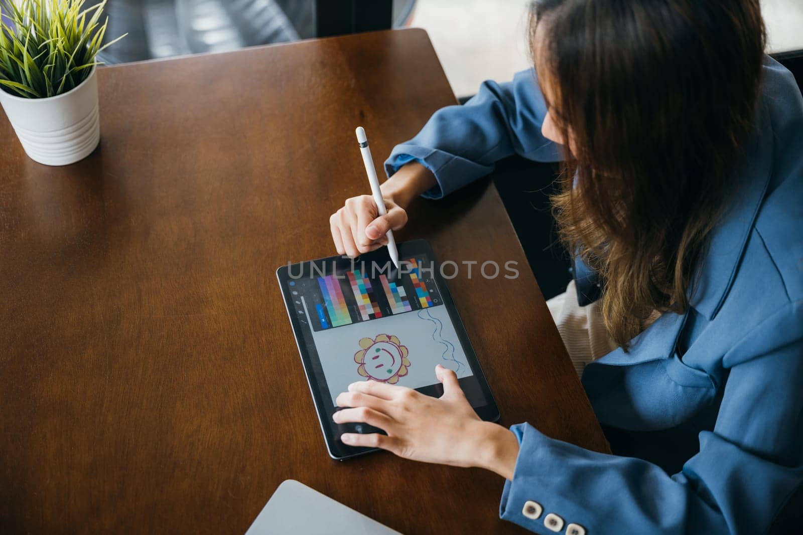 Lifestyle creative hobby woman digital artist draws a digital picture on digital tablet by Sorapop