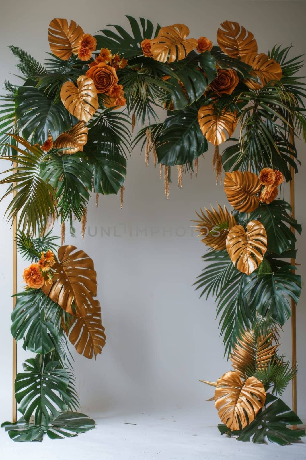 A tropical scene with gold and green leaves and flowers.