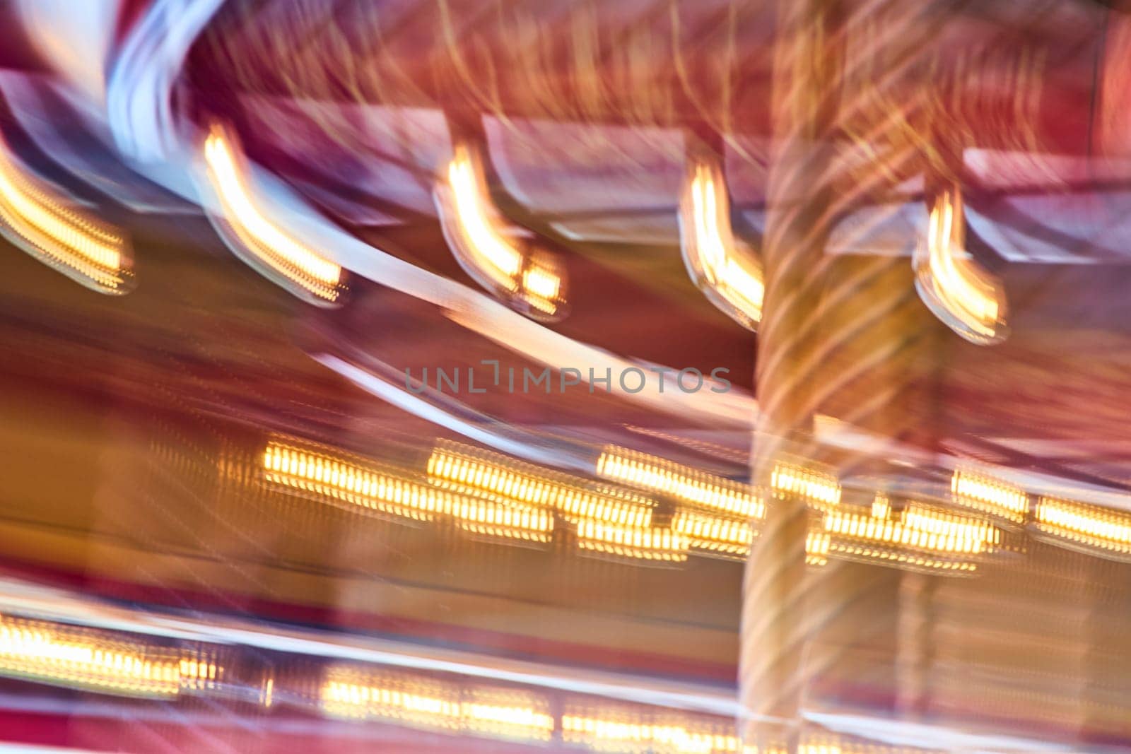 Vibrant carousel lights blur into a swirl of excitement at Fort Wayne Children's Zoo, Indiana.