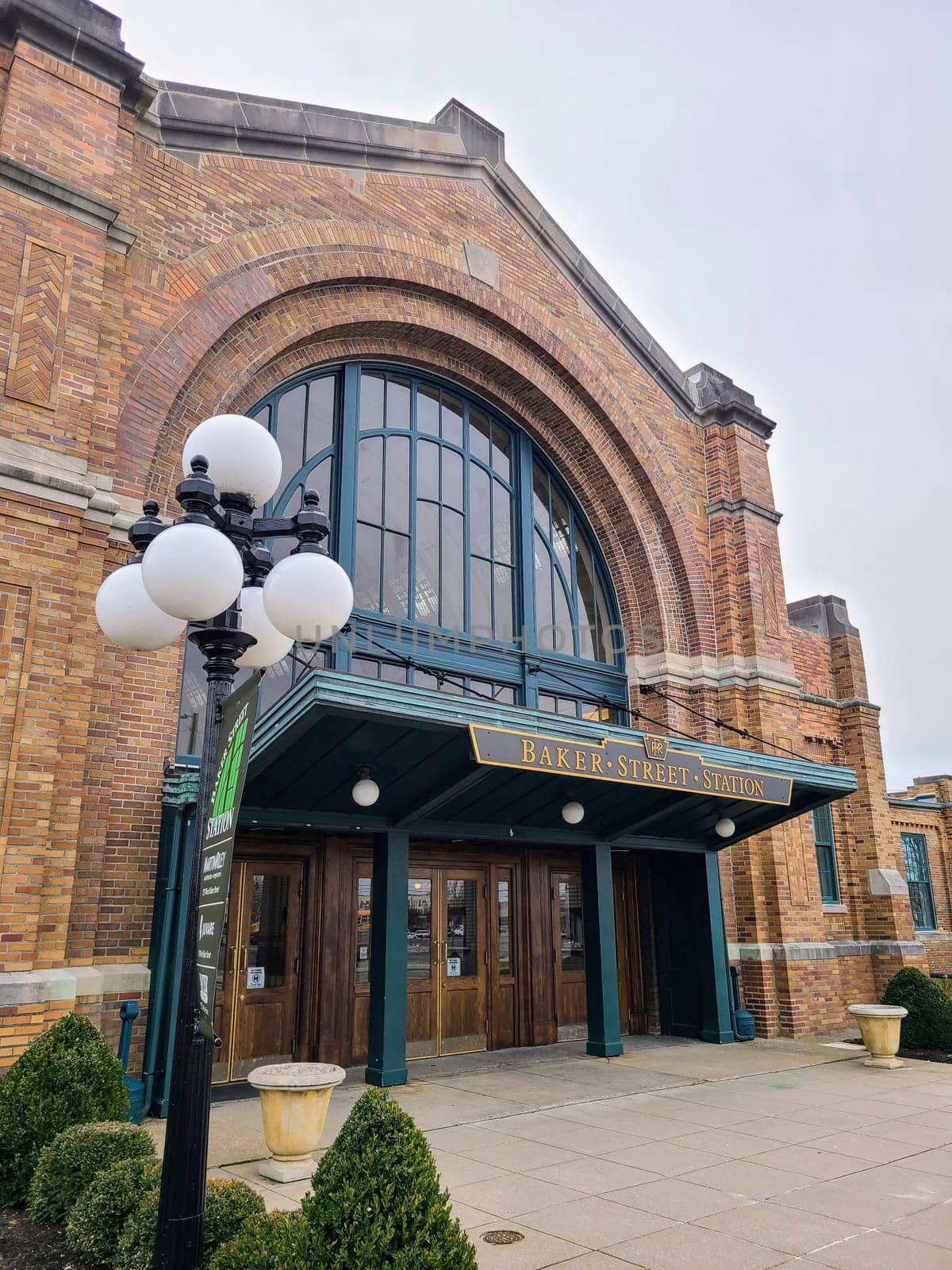 Baker Street Station entrance in Fort Wayne, featuring classical architecture with modern elements under a diffuse light.