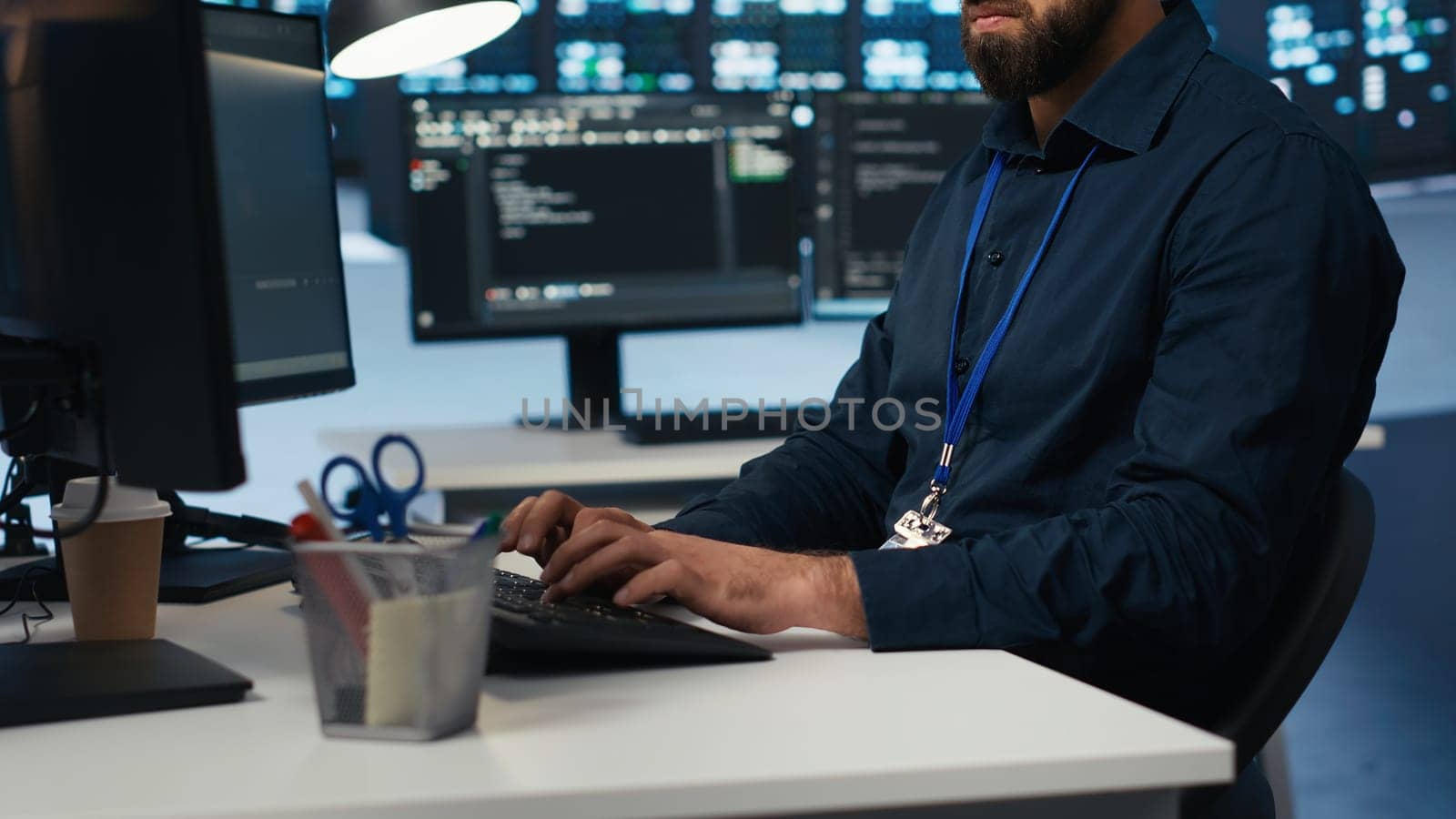 Proficient technician overseeing server room, running code on computer, troubleshooting servers. Software developer upgrading hardware clusters, networking systems and storage arrays