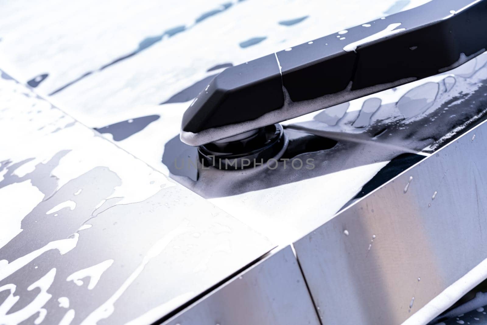 Detailed View of Tesla Cybertruck Windshield Wiper During Car Wash by arinahabich