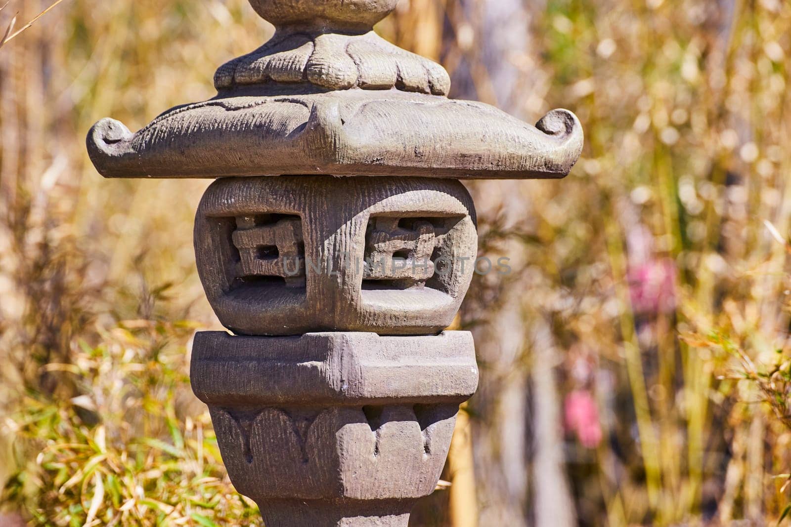 Ancient Asian stone lantern in a serene Japanese garden, symbolizing wisdom, Fort Wayne, Indiana.
