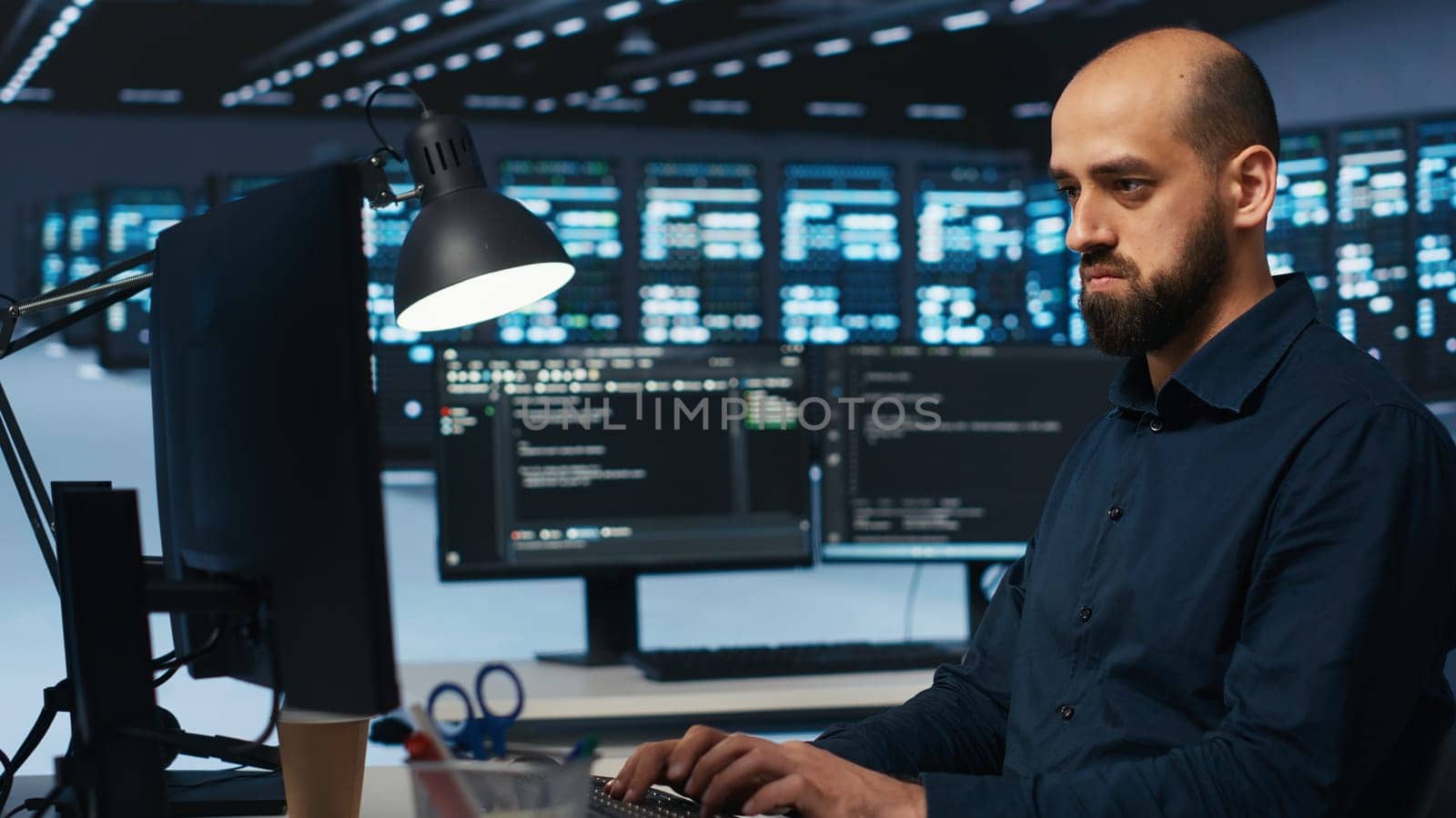 System administrator working in computer network security data center, ensuring optimal performance. Worker monitoring energy consumption across operational server racks components