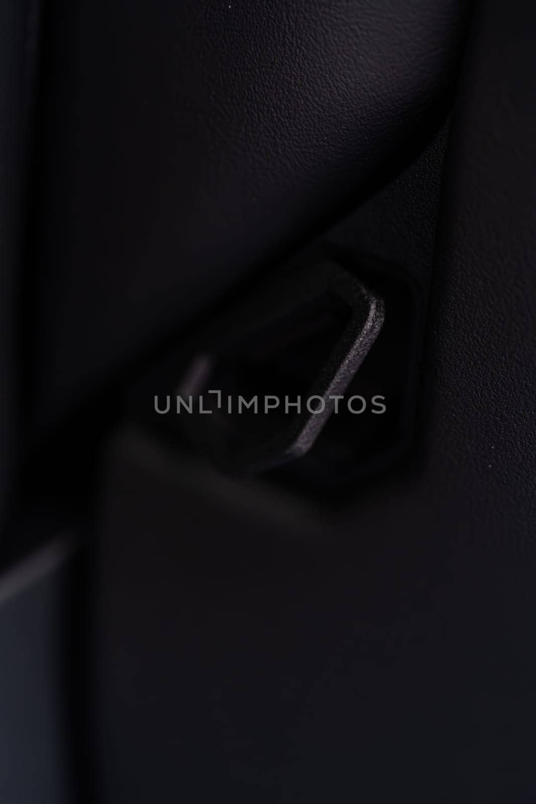 Denver, Colorado, USA-May 5, 2024-This image shows a detailed view of the back seat release pull strap in a Tesla Cybertruck, emphasizing the subtle yet functional design integrated within the vehicle interior.