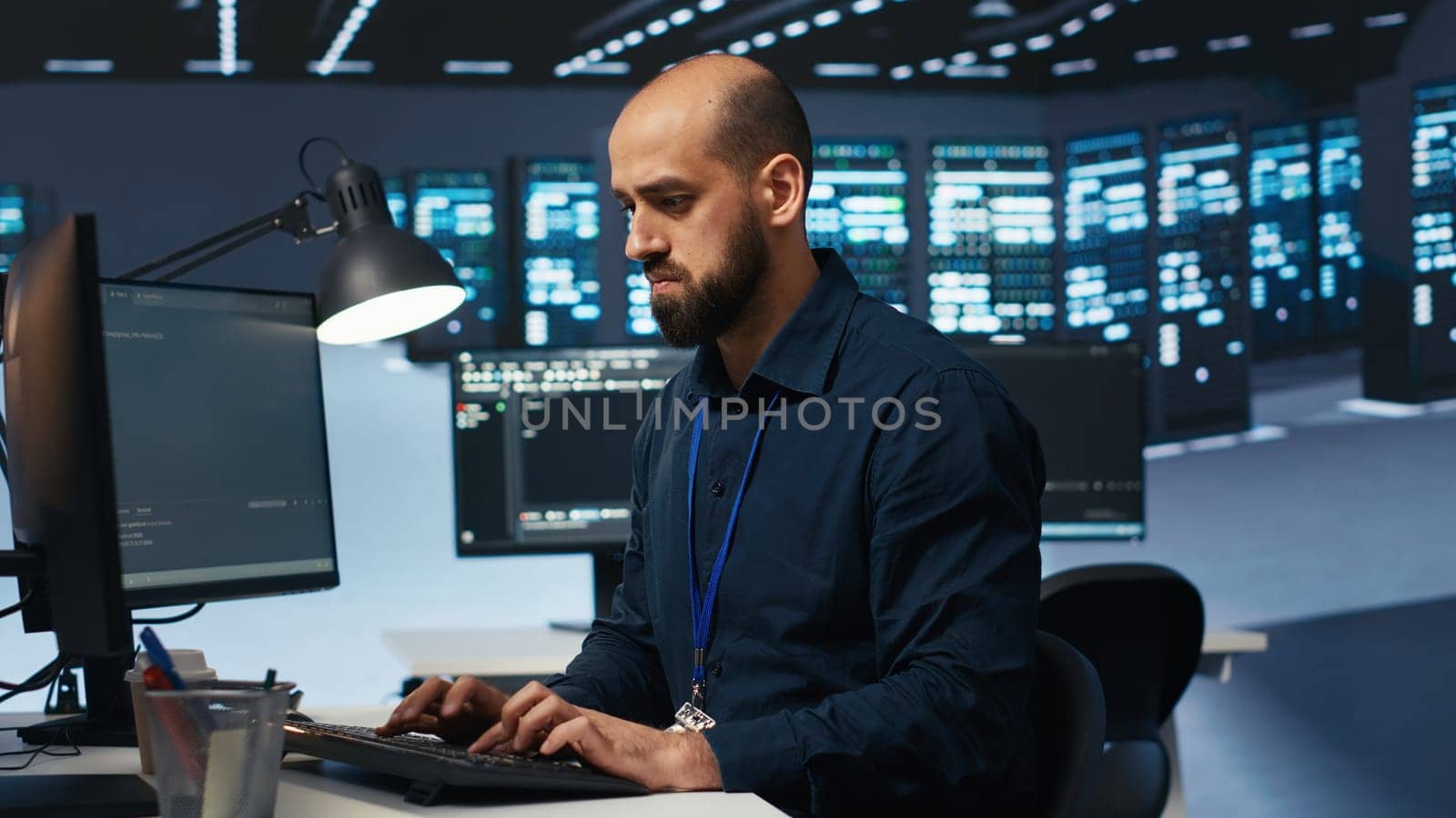 Engineer coding, working in data center facility hosting supercomputers by DCStudio
