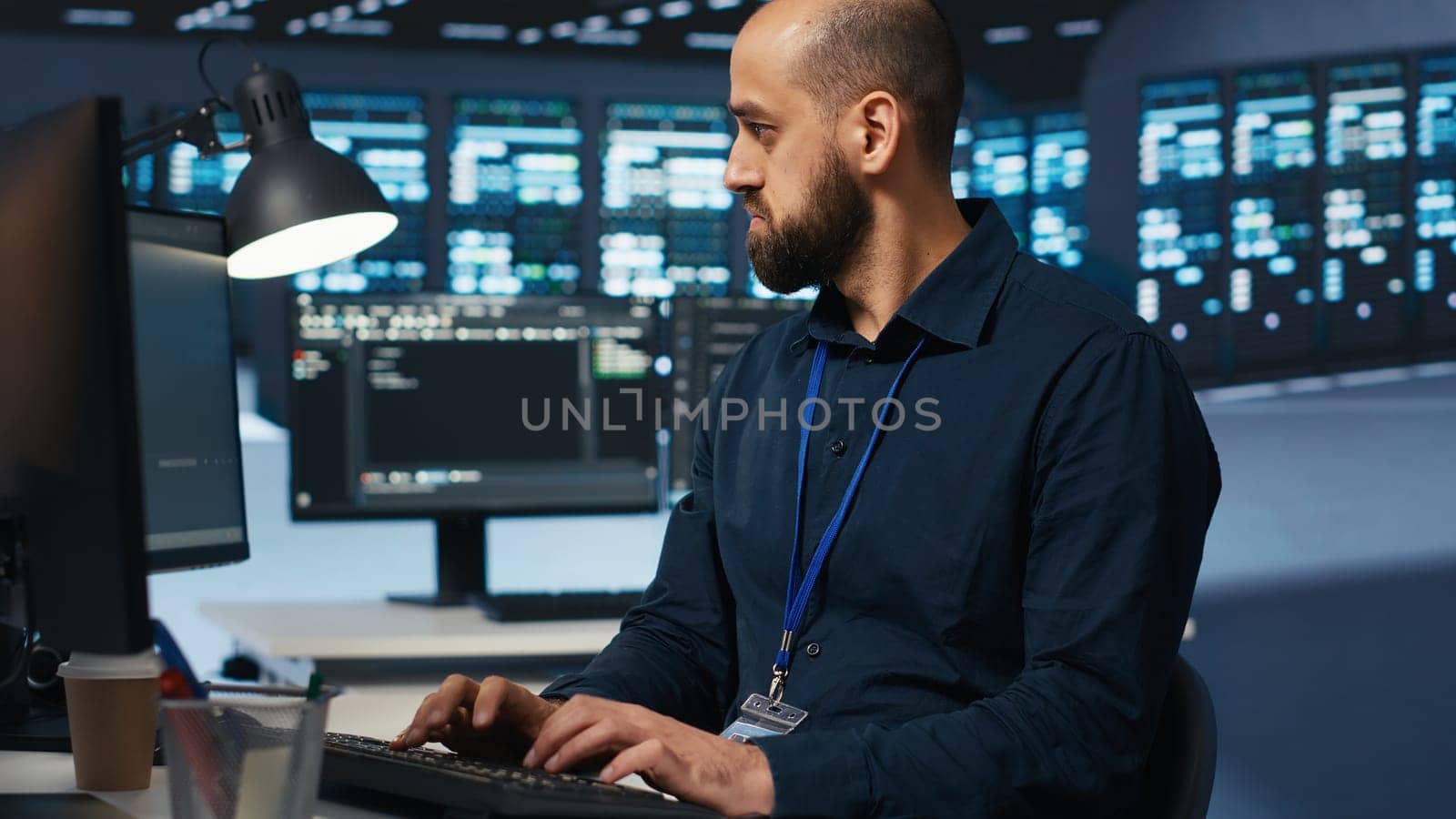 Computer scientist overseeing server hub, typing code on PC, troubleshooting rigs. Software professional doing maintenance on supercomputers, networking systems and storage arrays