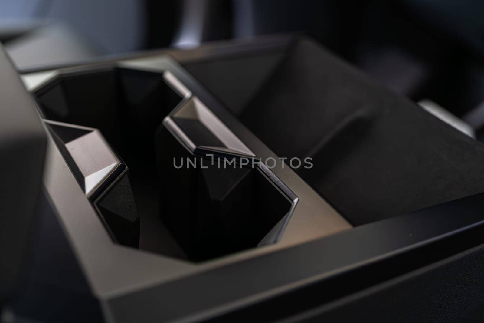 Denver, Colorado, USA-May 5, 2024-This image captures the innovative design of the cupholder inside the Tesla Cybertruck, showcasing its unique angular shapes and modern, minimalist aesthetic.