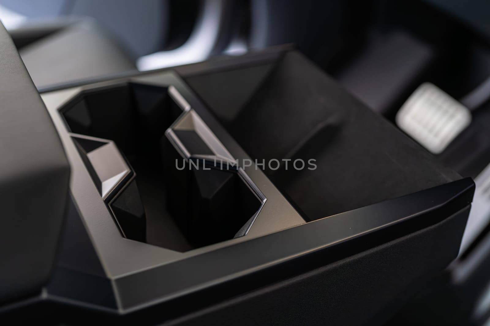 Denver, Colorado, USA-May 5, 2024-This image captures the innovative design of the cupholder inside the Tesla Cybertruck, showcasing its unique angular shapes and modern, minimalist aesthetic.