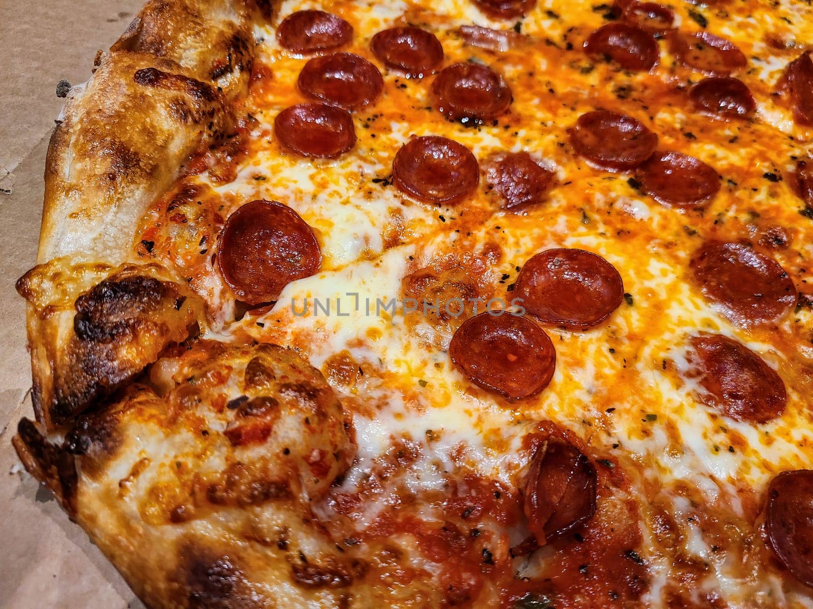 Close-up of a sizzling pepperoni pizza with crispy edges and bubbly cheese, perfect for a Fort Wayne feast.