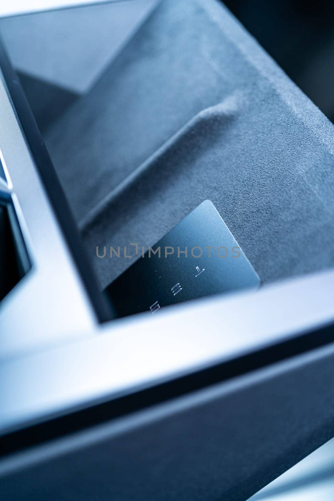 Denver, Colorado, USA-May 5, 2024-his image captures the sleek Tesla Cybertruck key card positioned neatly in the vehicle card holder, highlighting its minimalist design and emphasizing the modern aesthetic of Tesla innovative features.