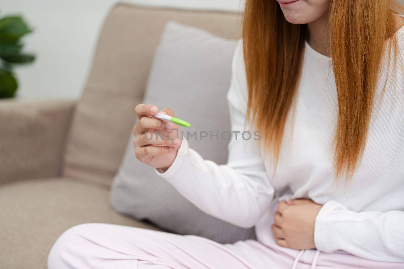 young woman hold in hands positive or negative pregnancy test thinking pondering, millennial female expecting baby undergo fertility infertility treatment.
