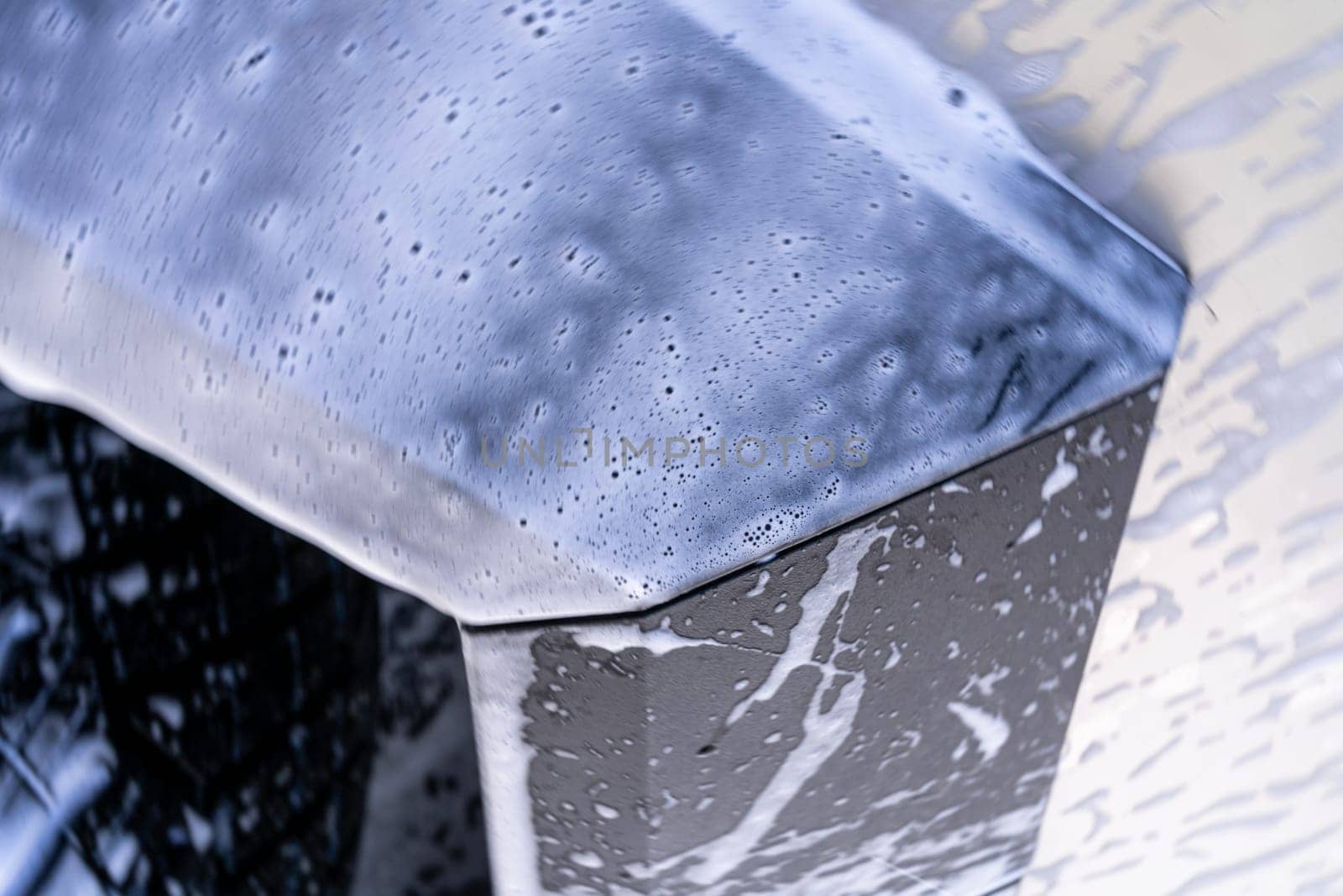 Denver, Colorado, USA-May 5, 2024-This image features a close-up view of the Tesla Cybertruck wheel and angular body design covered in soap and water during a thorough car wash, highlighting the unique textures and robust details of the electric truck.