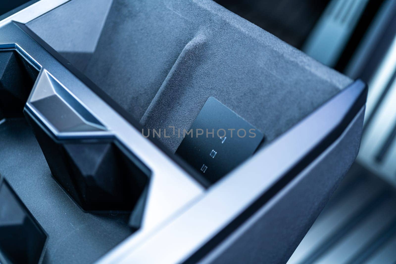 Denver, Colorado, USA-May 5, 2024-his image captures the sleek Tesla Cybertruck key card positioned neatly in the vehicle card holder, highlighting its minimalist design and emphasizing the modern aesthetic of Tesla innovative features.