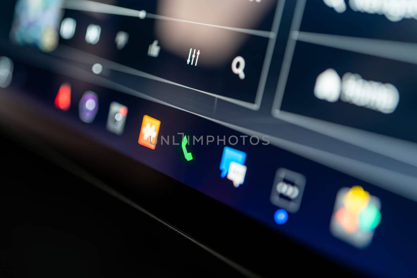 Denver, Colorado, USA-May 5, 2024-This image showcases a close-up view of the Tesla Cybertruck interactive touchscreen display, featuring vibrant icons for various vehicle controls. The focused lighting and high-resolution capture emphasize the sleek design and advanced technology integrated into the vehicle system.